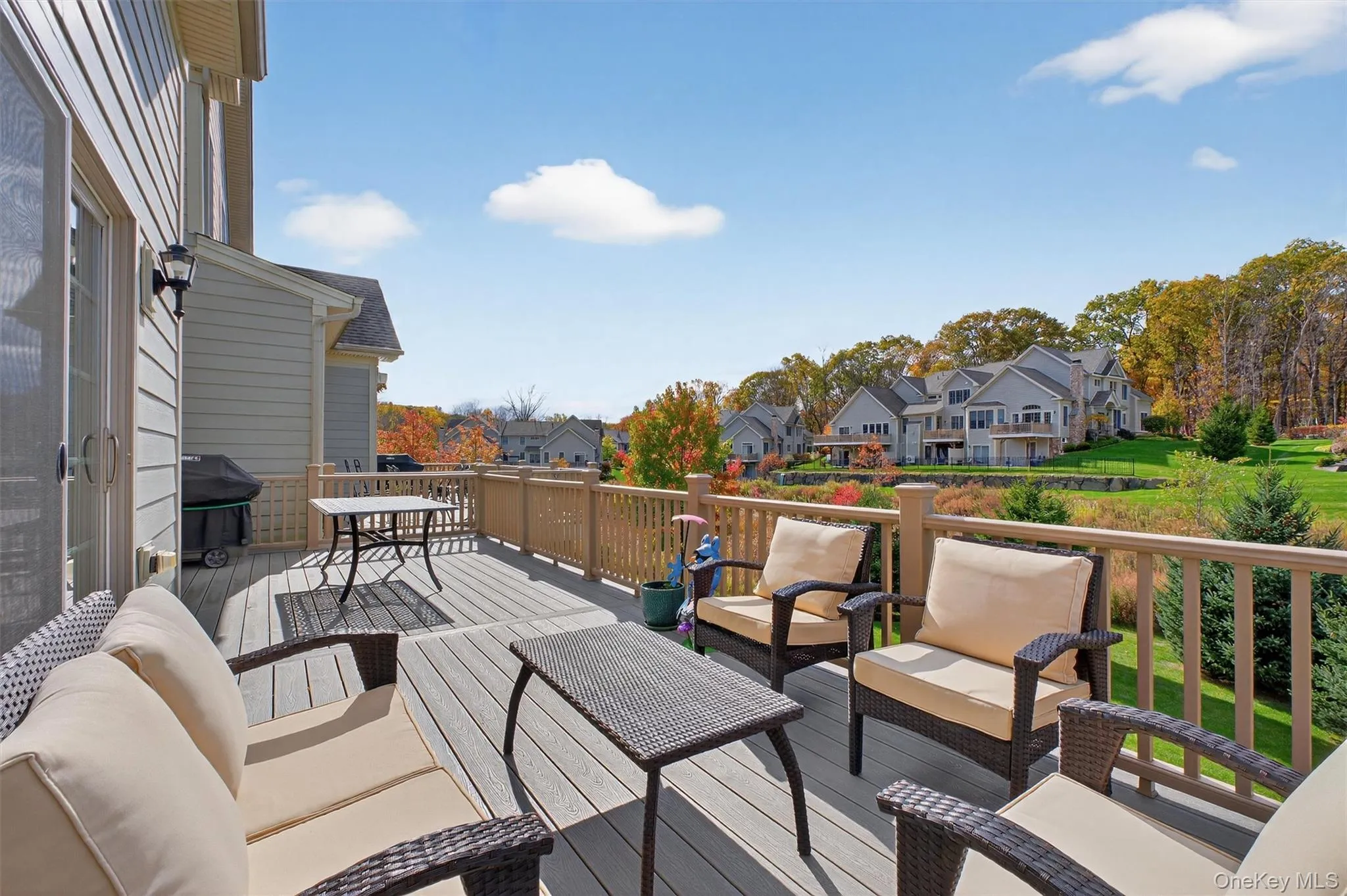 Wooden terrace with an outdoor hangout area, a residential view, and grilling area Wooden terrace with an outdoor hangout area, a residential view, and grilling area