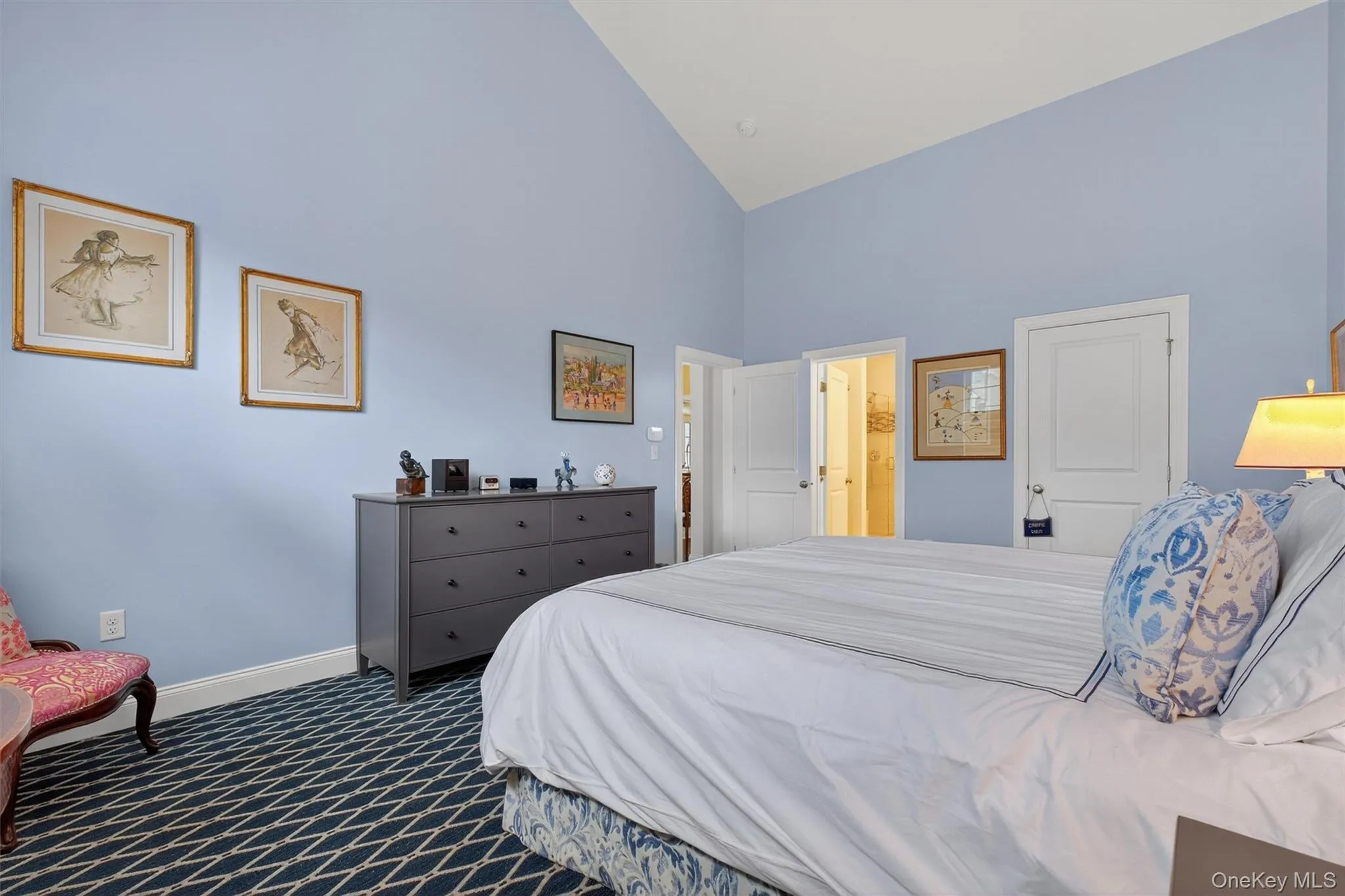 Bedroom featuring high vaulted ceiling and dark carpet Bedroom featuring high vaulted ceiling and dark carpet