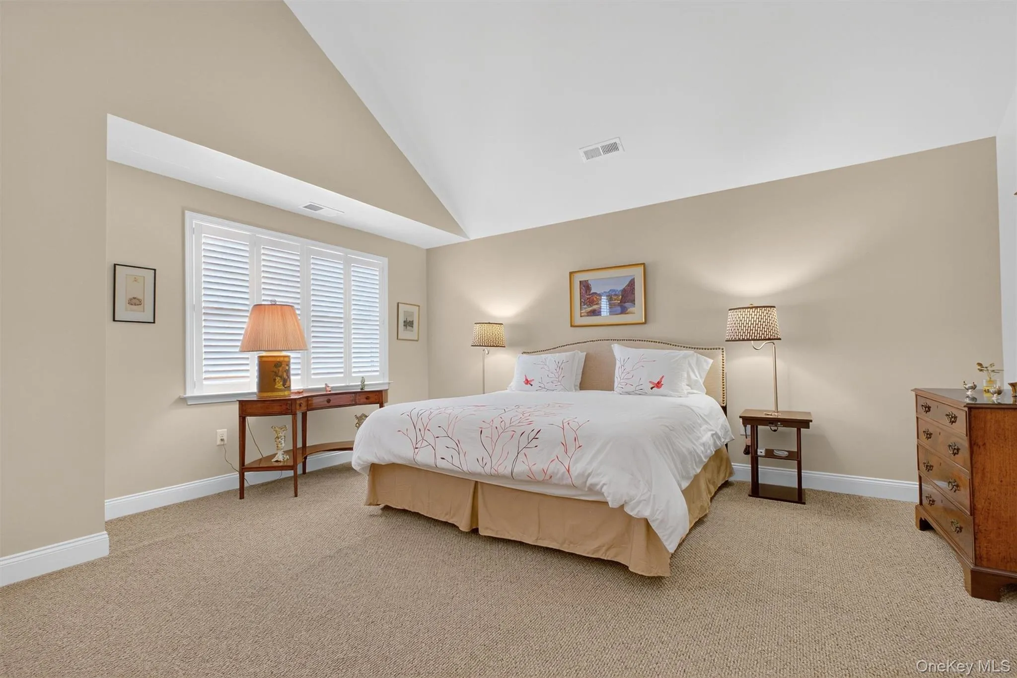 Bedroom with high vaulted ceiling and light colored carpet Bedroom with high vaulted ceiling and light colored carpet