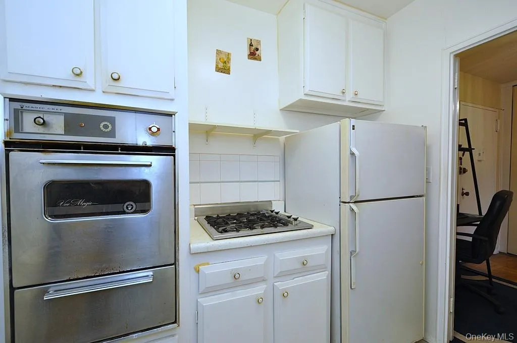 Kitchen has a refrigerator, stove top and wall oven. Kitchen has a refrigerator, stove top and wall oven.