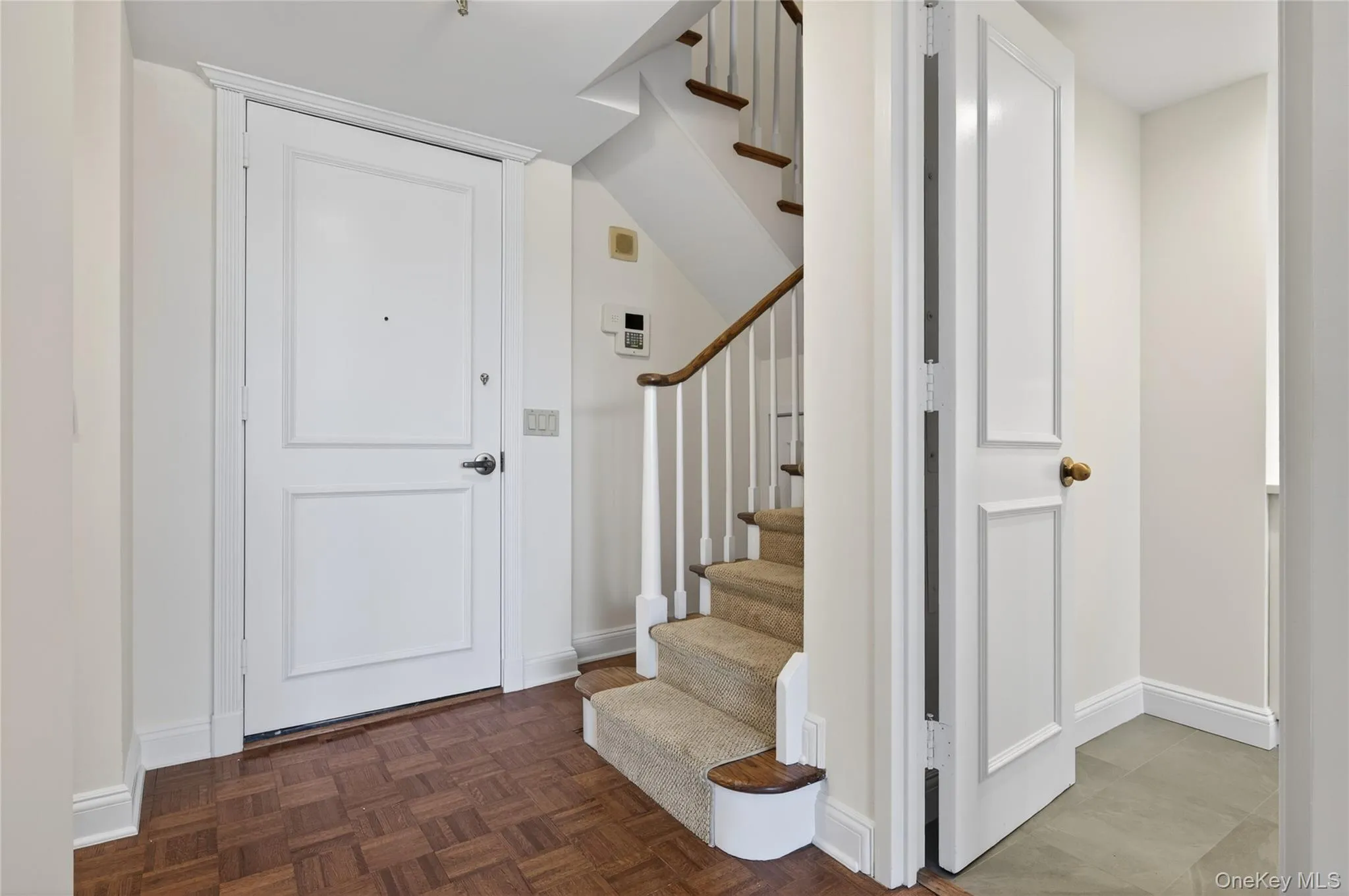 Entryway of apartment and staircase leading to second level Entryway of apartment and staircase leading to second level