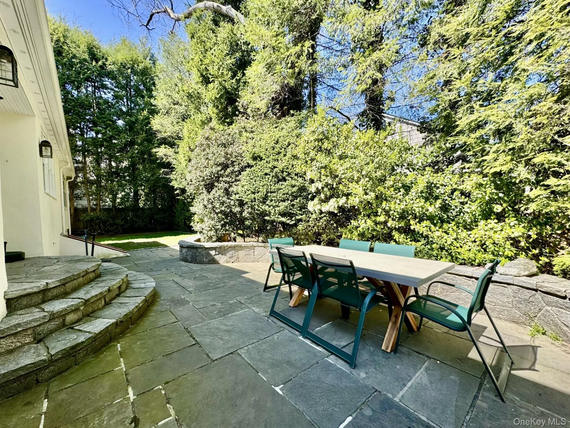 Large Private Flagstone Patio opens to grassy lawn area. Easy access thru Glass French doors in the Kitchen, perfect for entertaining. Large Private Flagstone Patio opens to grassy lawn area. Easy access thru Glass French doors in the Kitchen, perfect for entertaining.