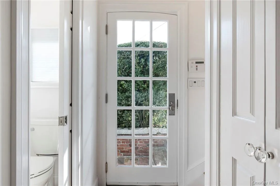 Convenient sunny side entrance area features easy access to Renovated Powder Room with clever pocket door, Coat Closet and Kitchen. Convenient sunny side entrance area features easy access to Renovated Powder Room with clever pocket door, Coat Closet and Kitchen.