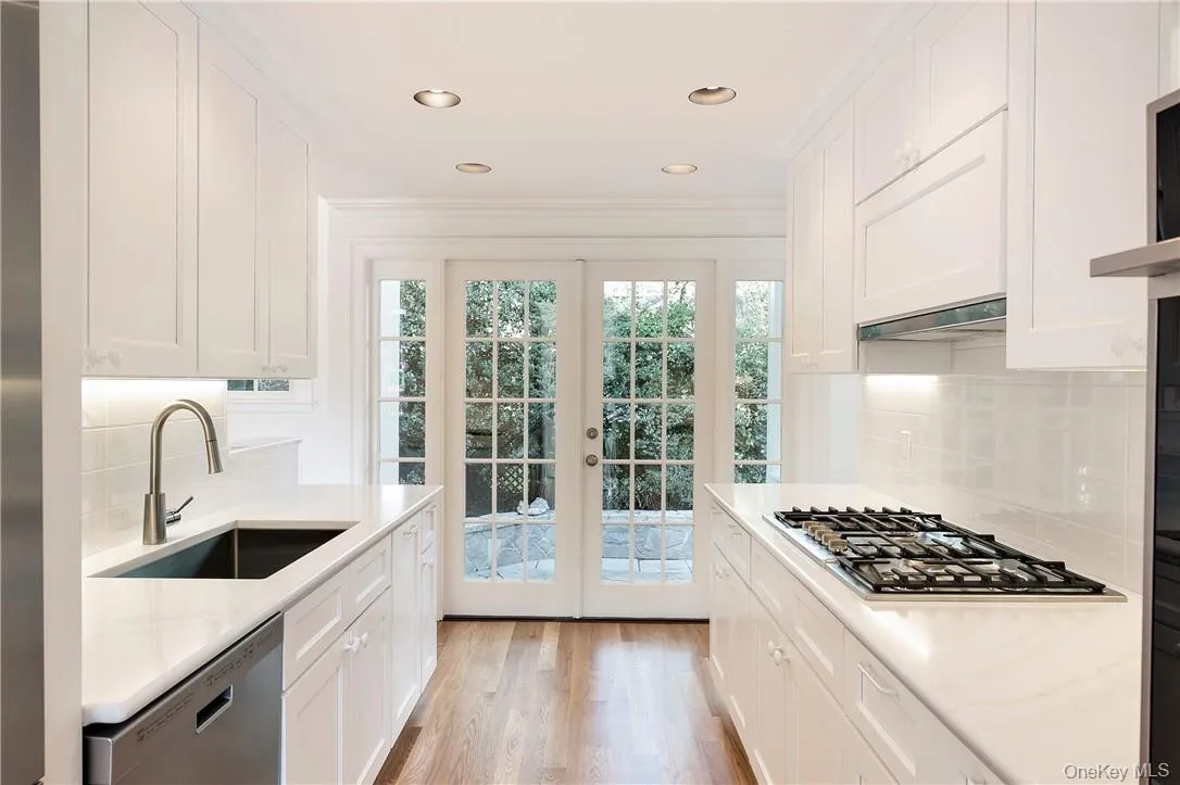 French Doors open to large flagstone patio with sitting wall. French Doors open to large flagstone patio with sitting wall.