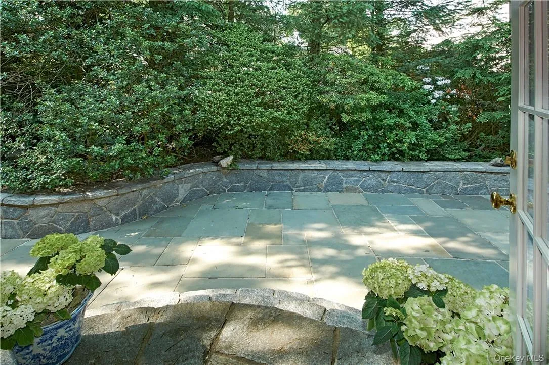 Large Private Flagstone Patio with unique stone sitting wall. Large Private Flagstone Patio with unique stone sitting wall.