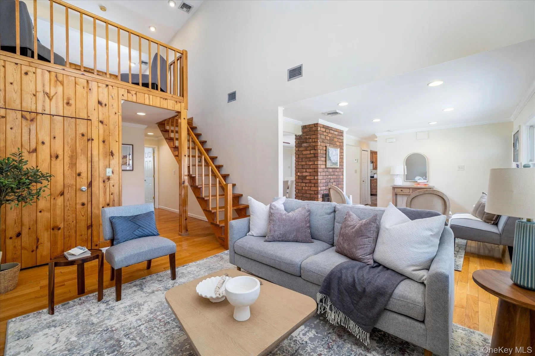 Wood paneled wall, recessed lighting, crown molding, and a high ceiling Wood paneled wall, recessed lighting, crown molding, and a high ceiling