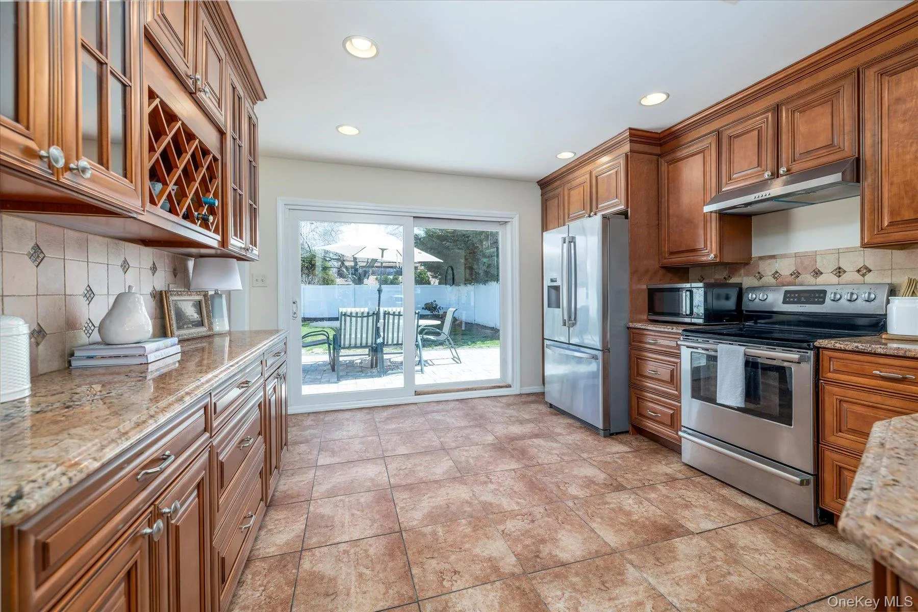 Eat in kitchen with stainless steel appliances, granite counters and tile floors Eat in kitchen with stainless steel appliances, granite counters and tile floors