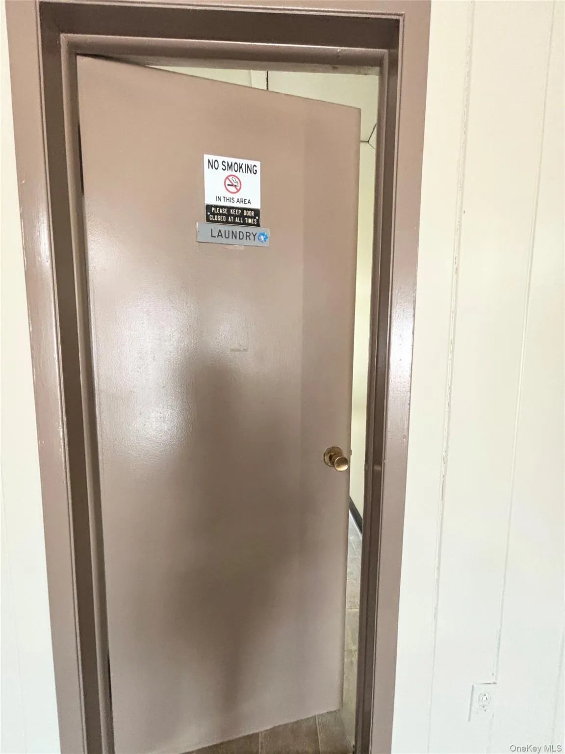 Door to laundry room in building Door to laundry room in building