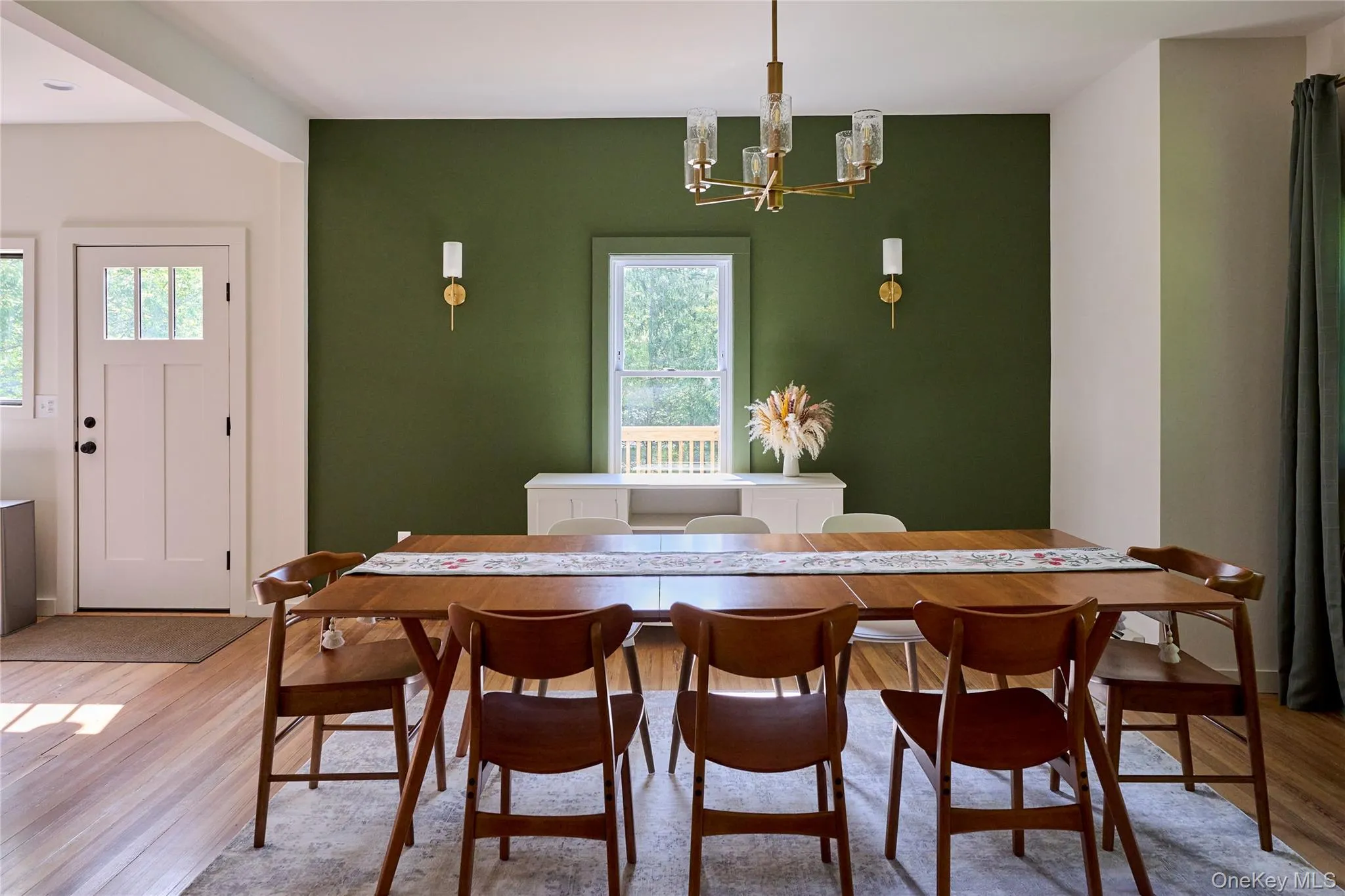 Dining area featuring healthy amount of natural light, a chandelier, and wood finished floors Dining area featuring healthy amount of natural light, a chandelier, and wood finished floors