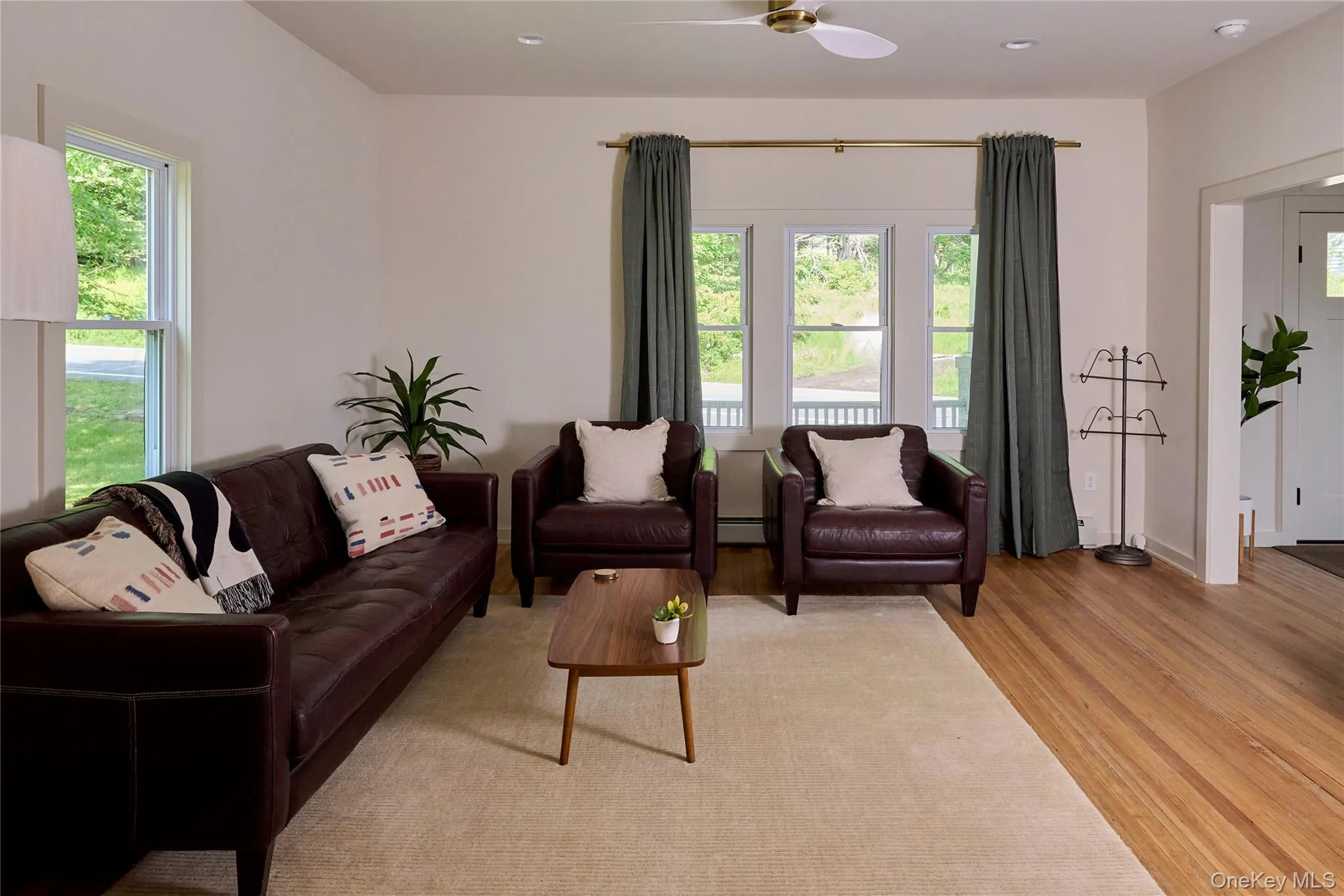 Living area featuring light wood finished floors, ceiling fan, and recessed lighting Living area featuring light wood finished floors, ceiling fan, and recessed lighting