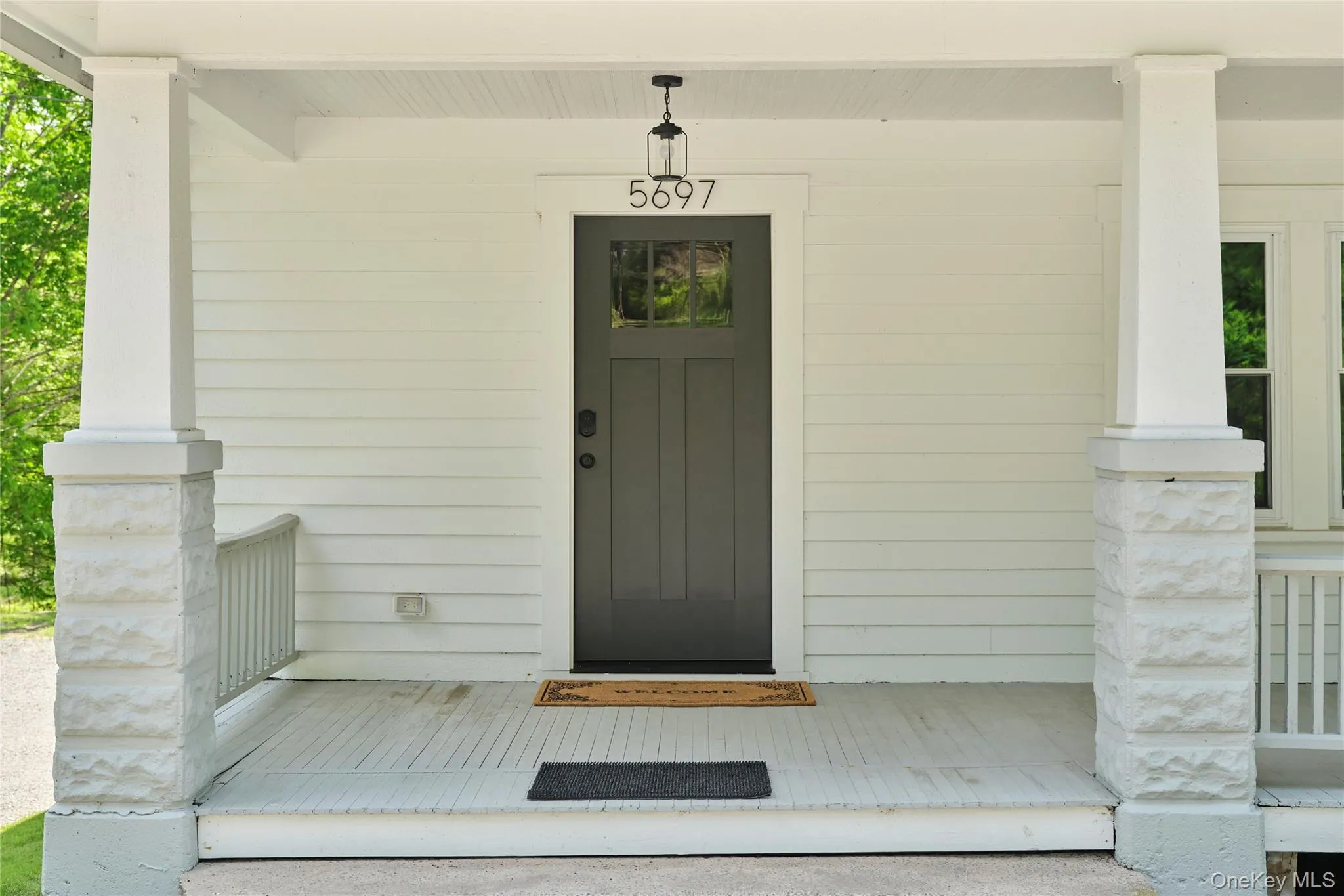 Doorway to property featuring covered porch Doorway to property featuring covered porch
