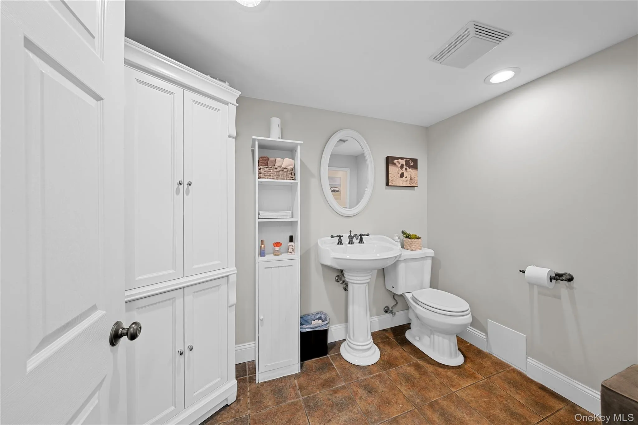 Bathroom featuring recessed lighting and dark tile patterned floors Bathroom featuring recessed lighting and dark tile patterned floors
