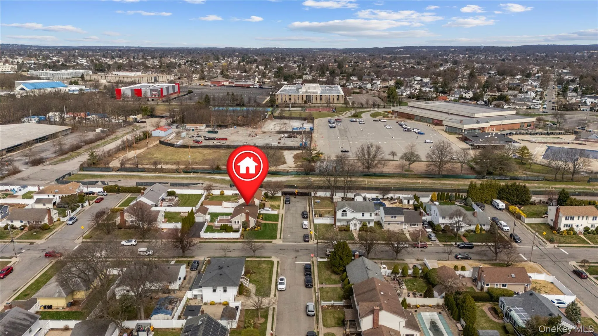 Aerial view of property's location featuring nearby suburban area showing nearby school Aerial view of property's location featuring nearby suburban area showing nearby school