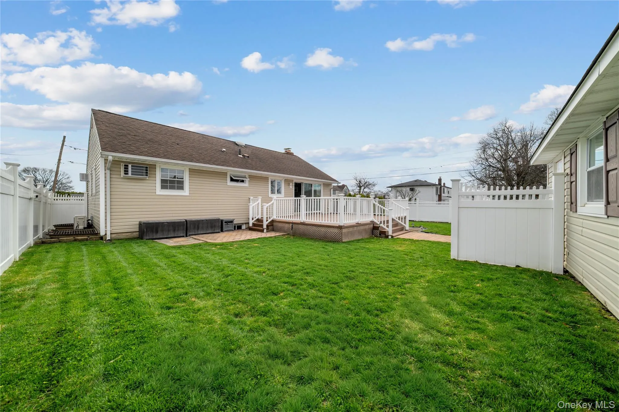 Rear view of property featuring a wooden deck and a fenced backyard Rear view of property featuring a wooden deck and a fenced backyard