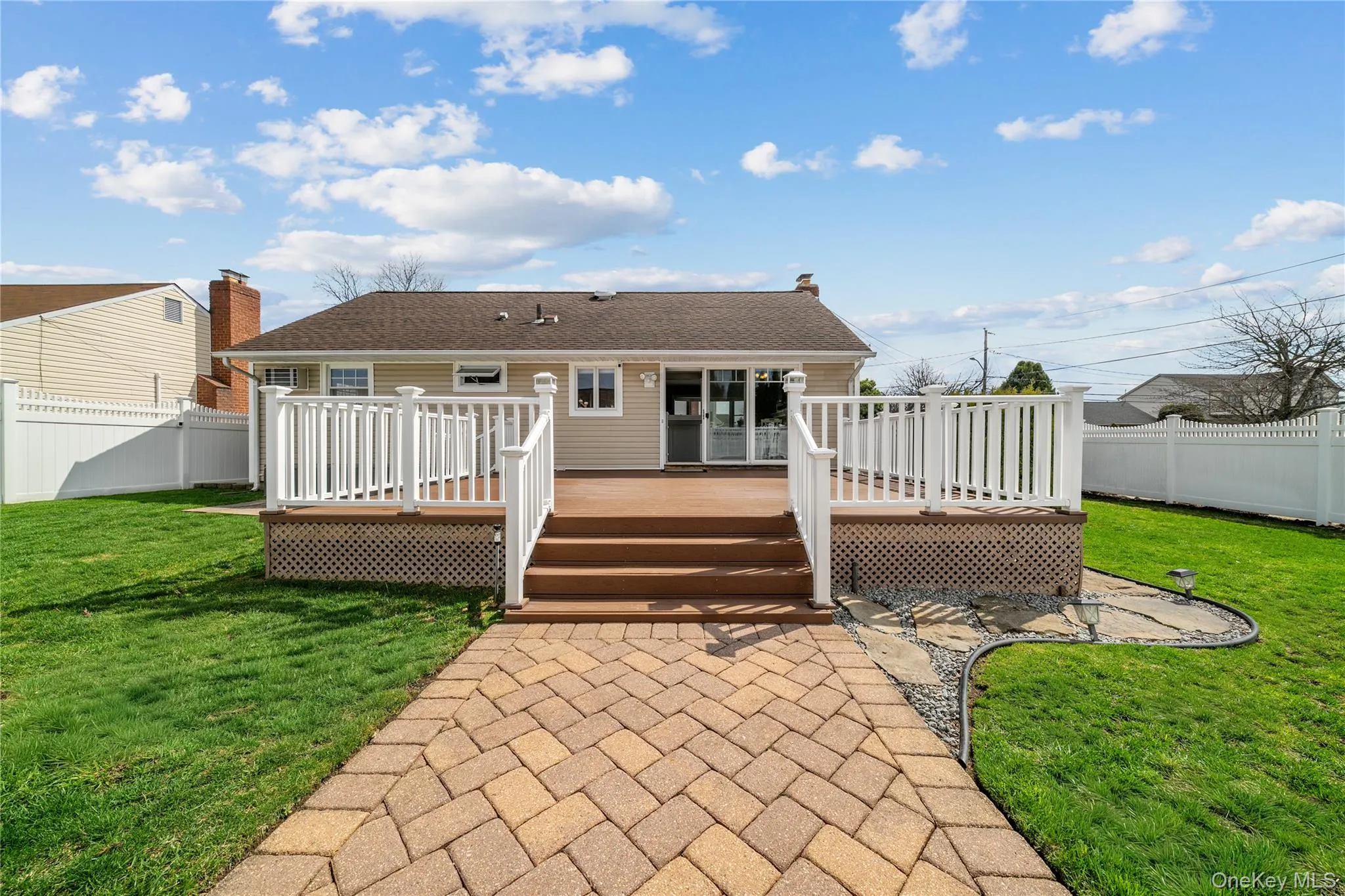 Rear view of house featuring a fenced backyard, a wooden deck, and roof with shingles Rear view of house featuring a fenced backyard, a wooden deck, and roof with shingles
