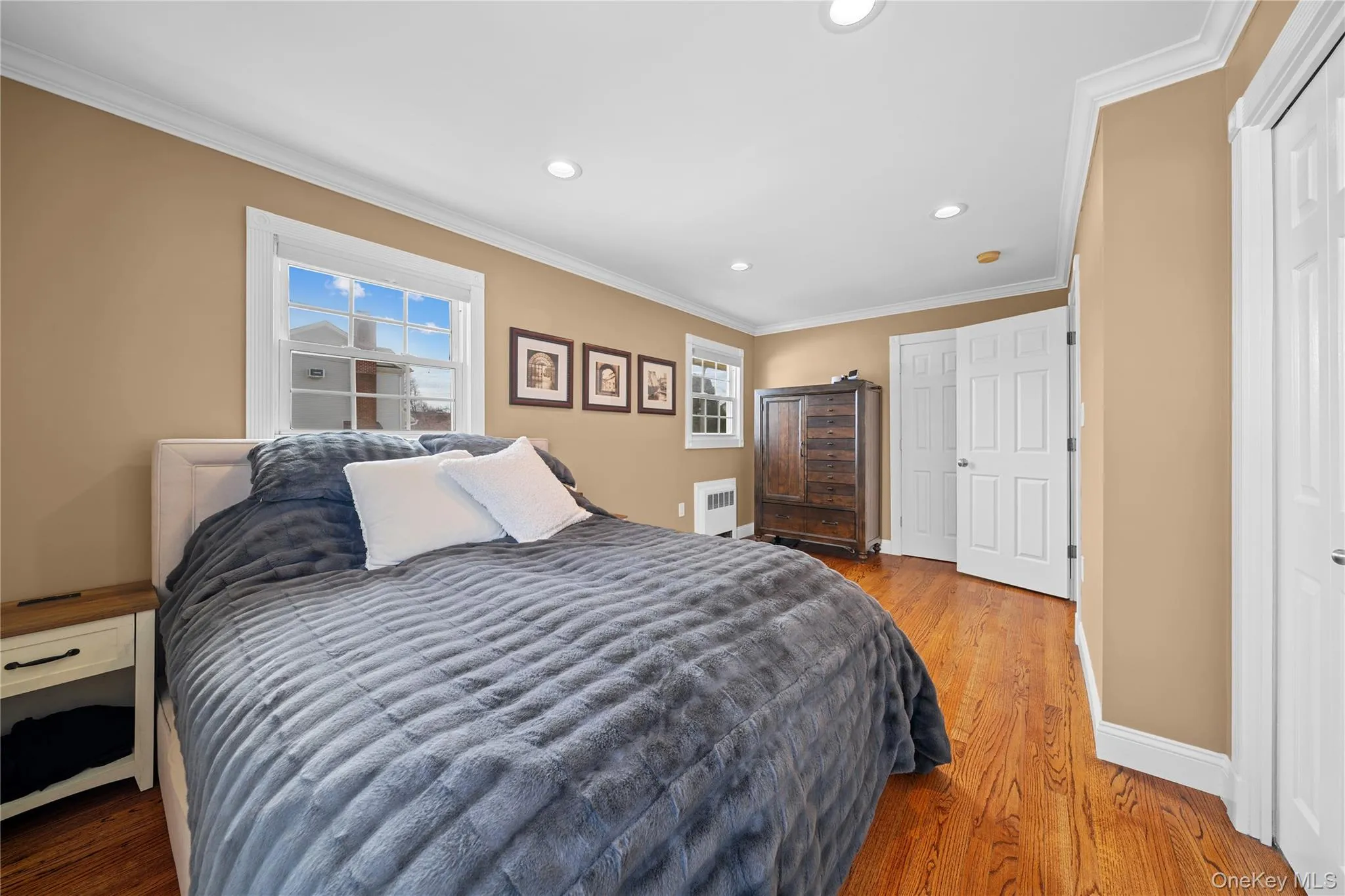 Bedroom featuring crown molding, recessed lighting, wood finished floors, double sized room Bedroom featuring crown molding, recessed lighting, wood finished floors, double sized room