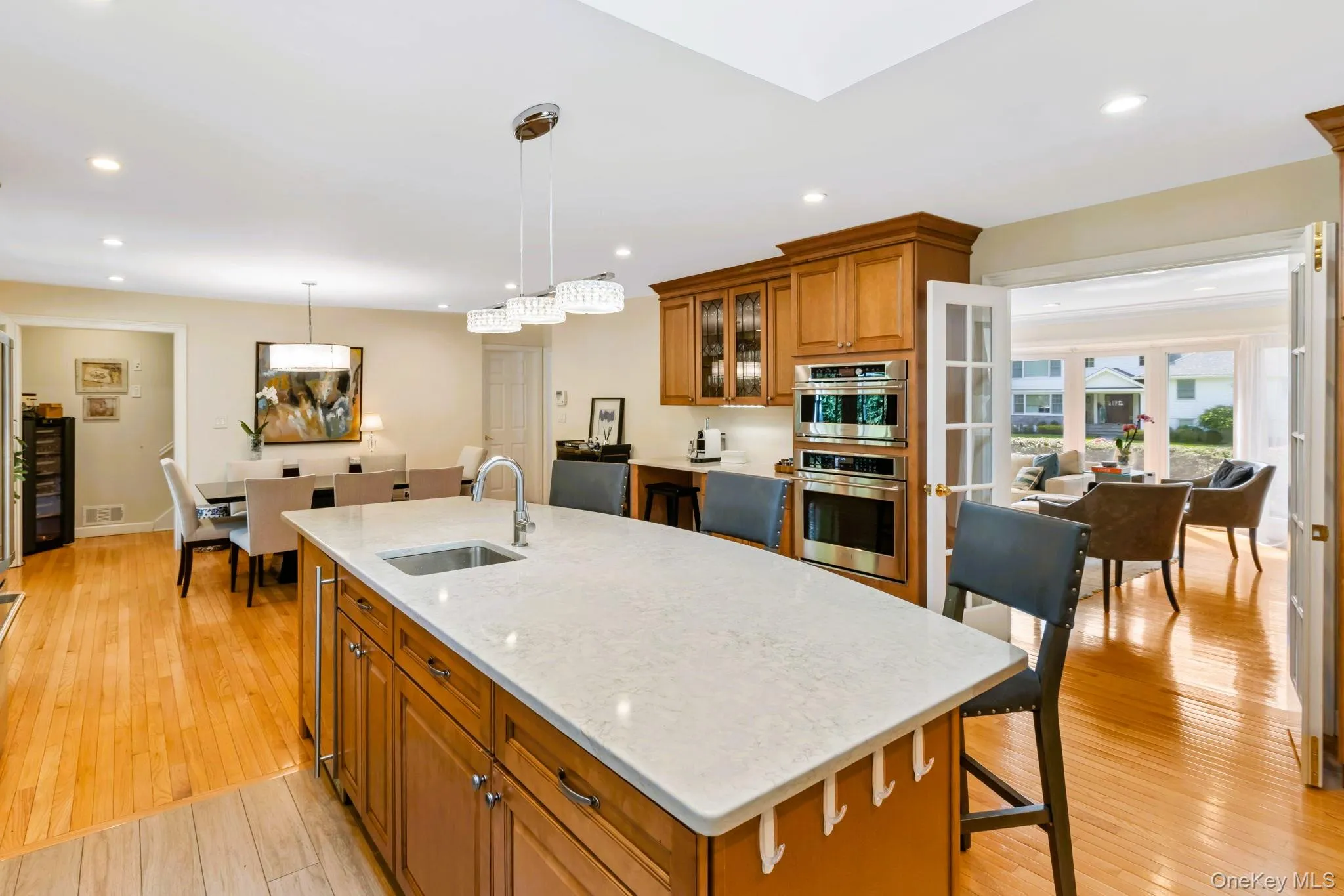 Kitchen with stainless steel appliances, a skylight, and oversized island Kitchen with stainless steel appliances, a skylight, and oversized island