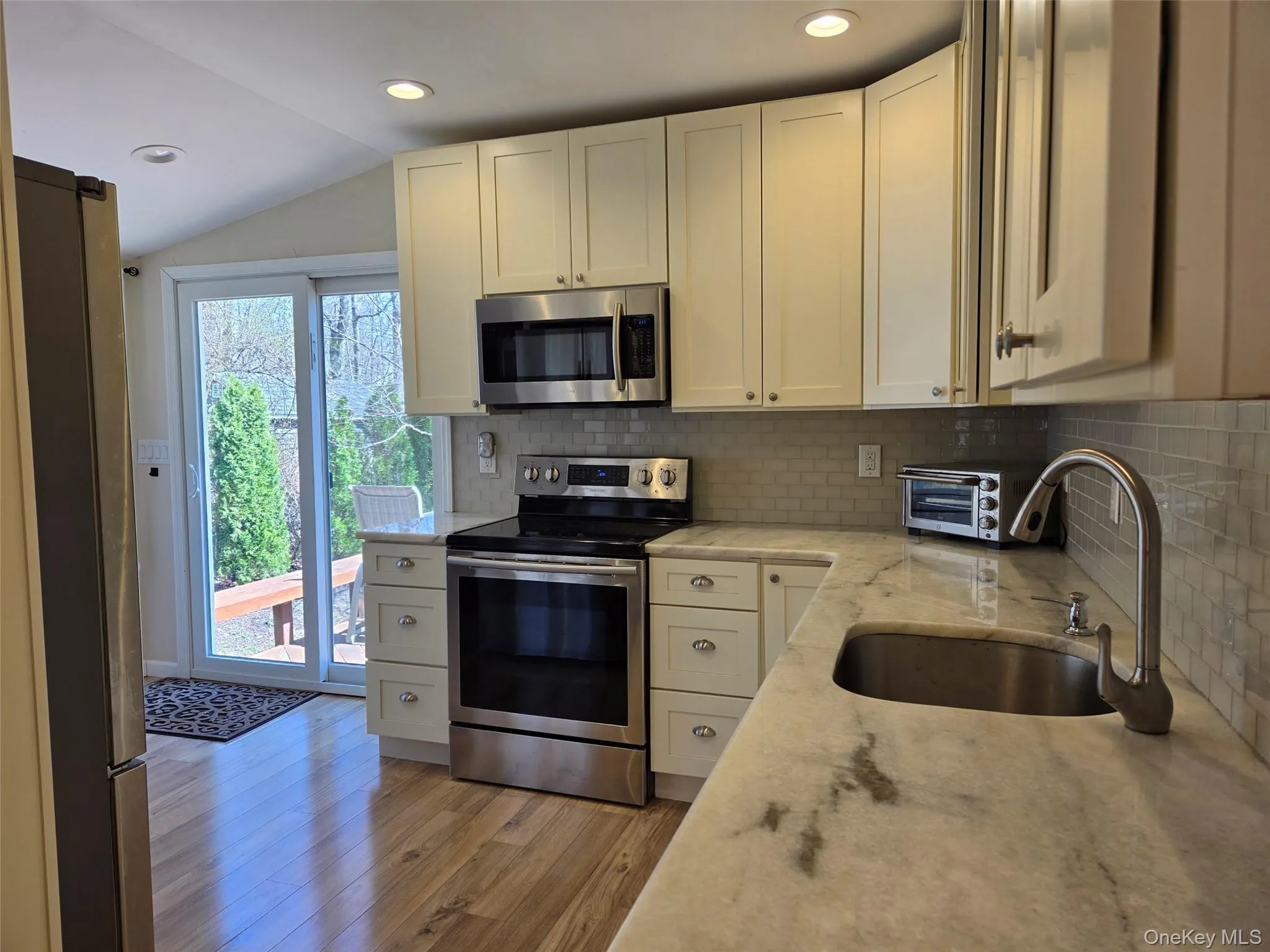 modern kit, quartz ctrs, tiled backsplash, SS appli, recessed lite, slider to deck modern kit, quartz ctrs, tiled backsplash, SS appli, recessed lite, slider to deck