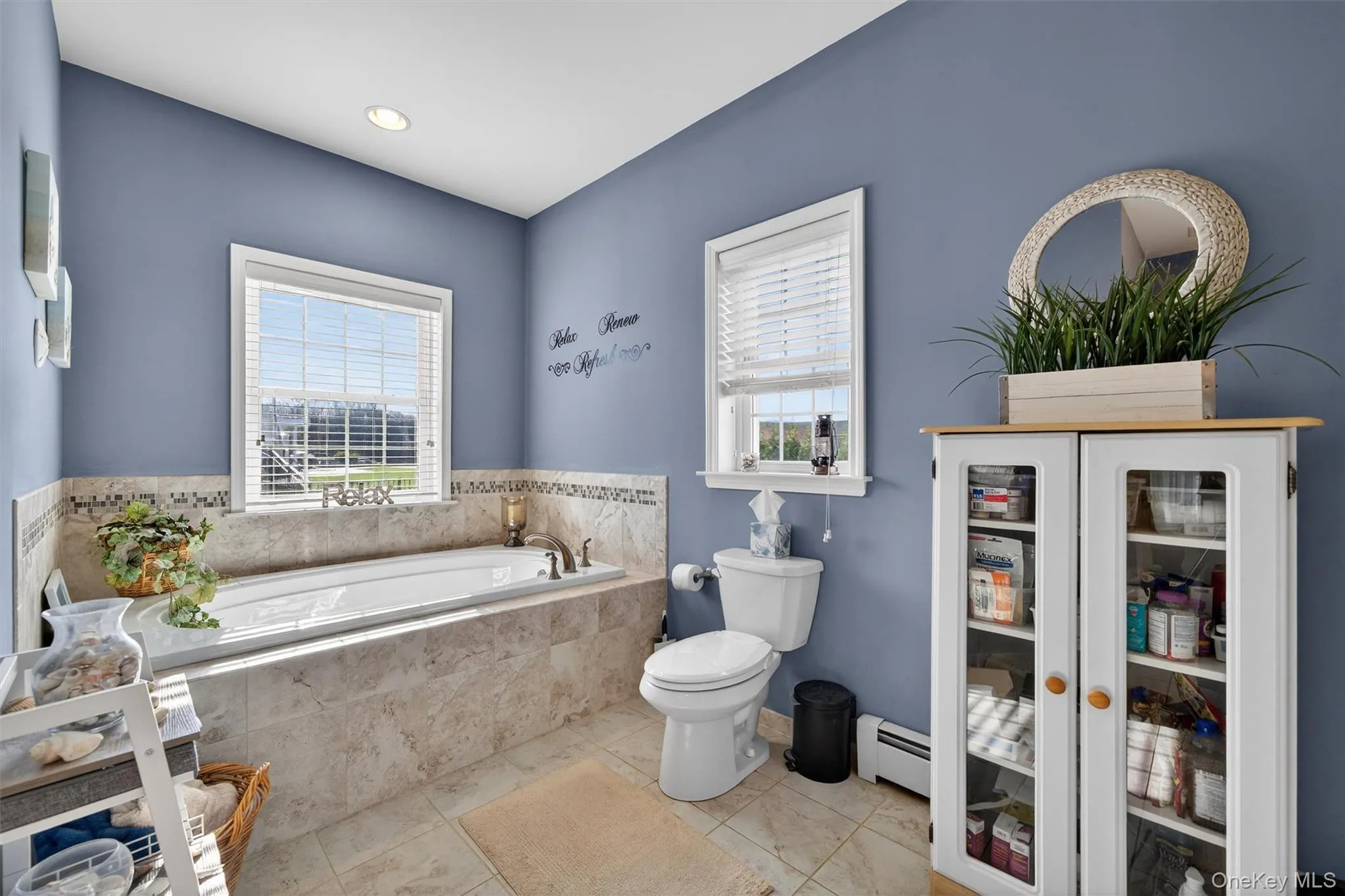 Full bathroom with a garden tub and a baseboard radiator Full bathroom with a garden tub and a baseboard radiator