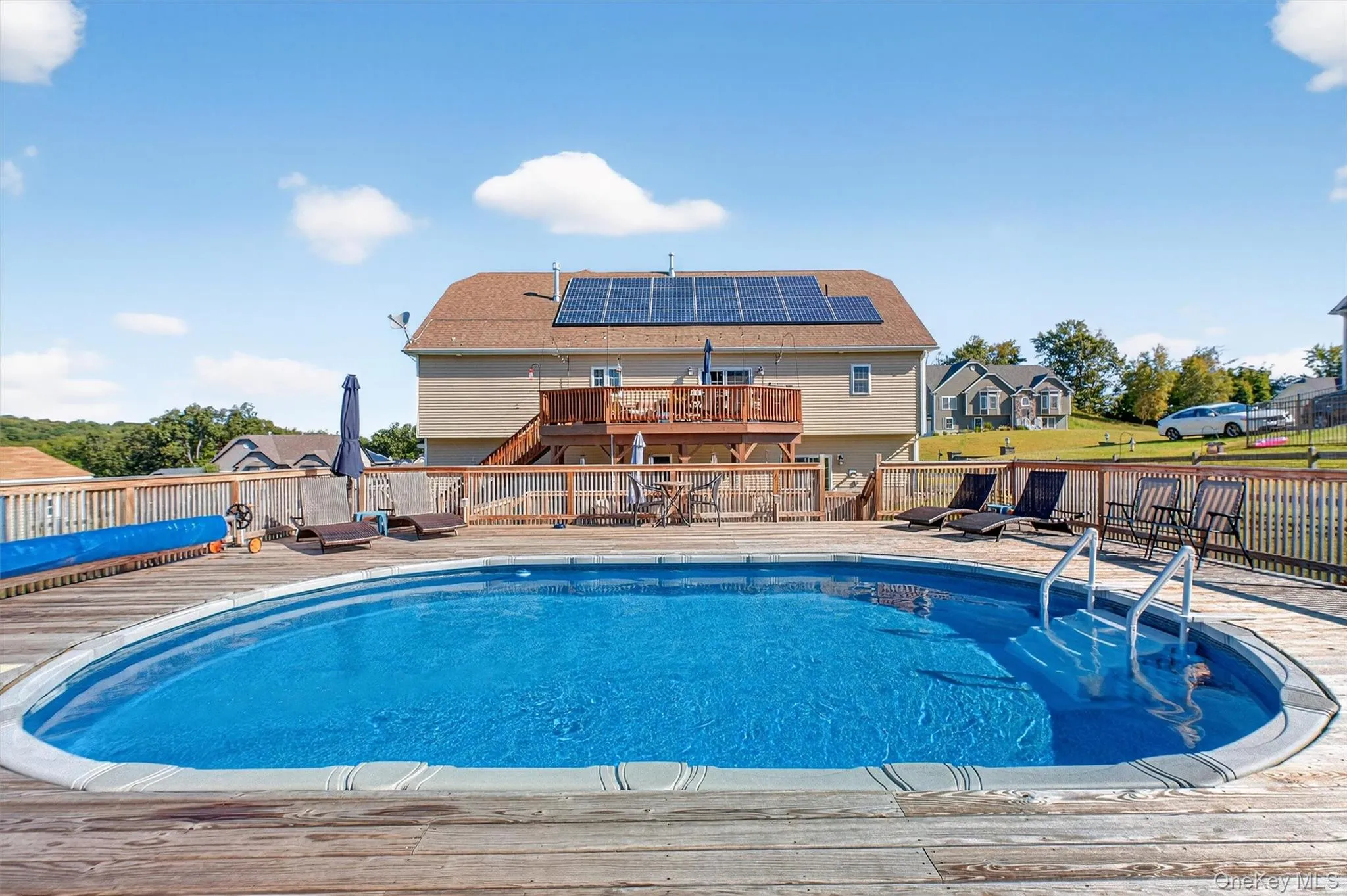 View of pool with a wooden deck View of pool with a wooden deck