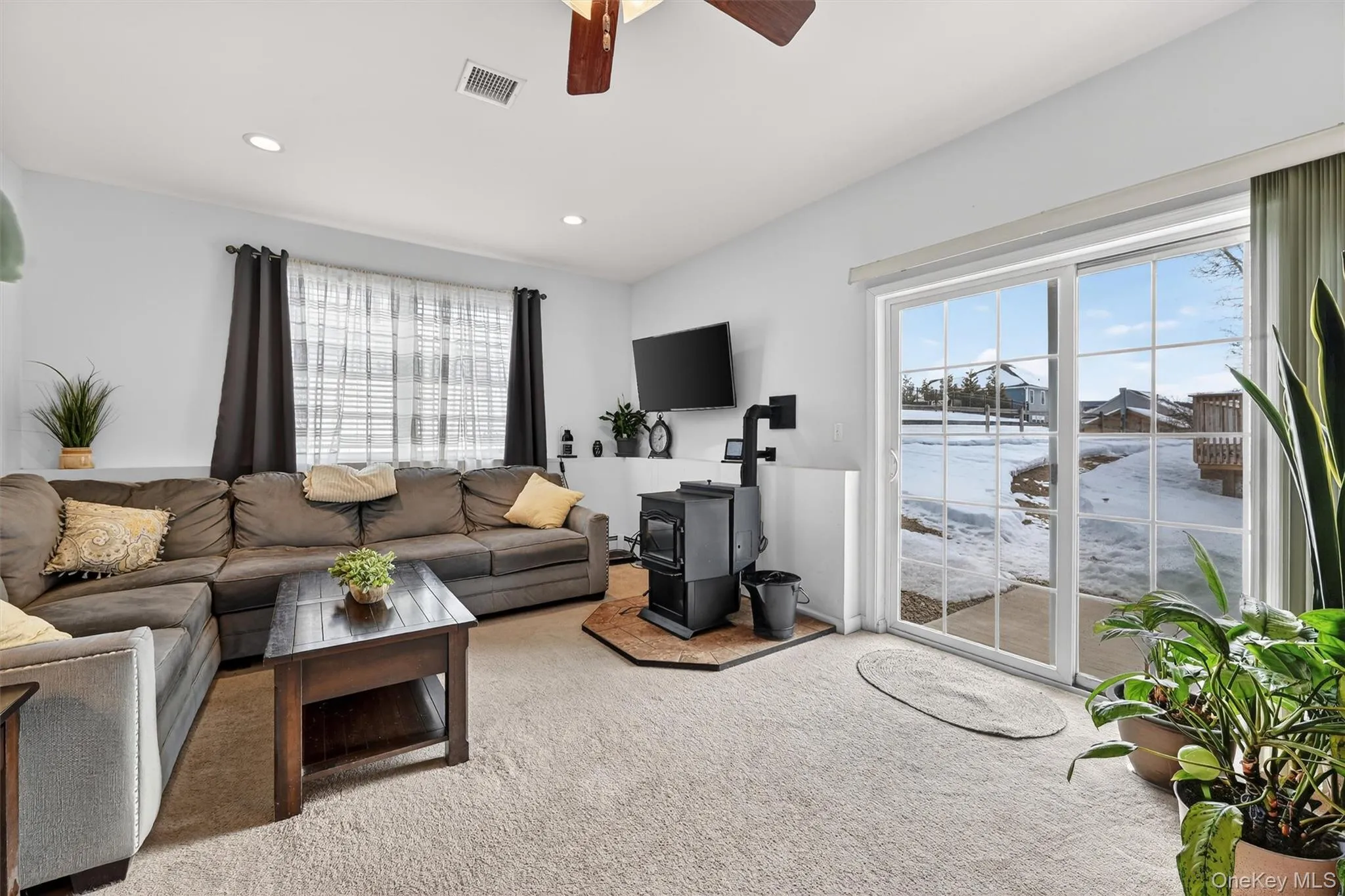 Carpeted living room with ceiling fan and recessed lighting Carpeted living room with ceiling fan and recessed lighting