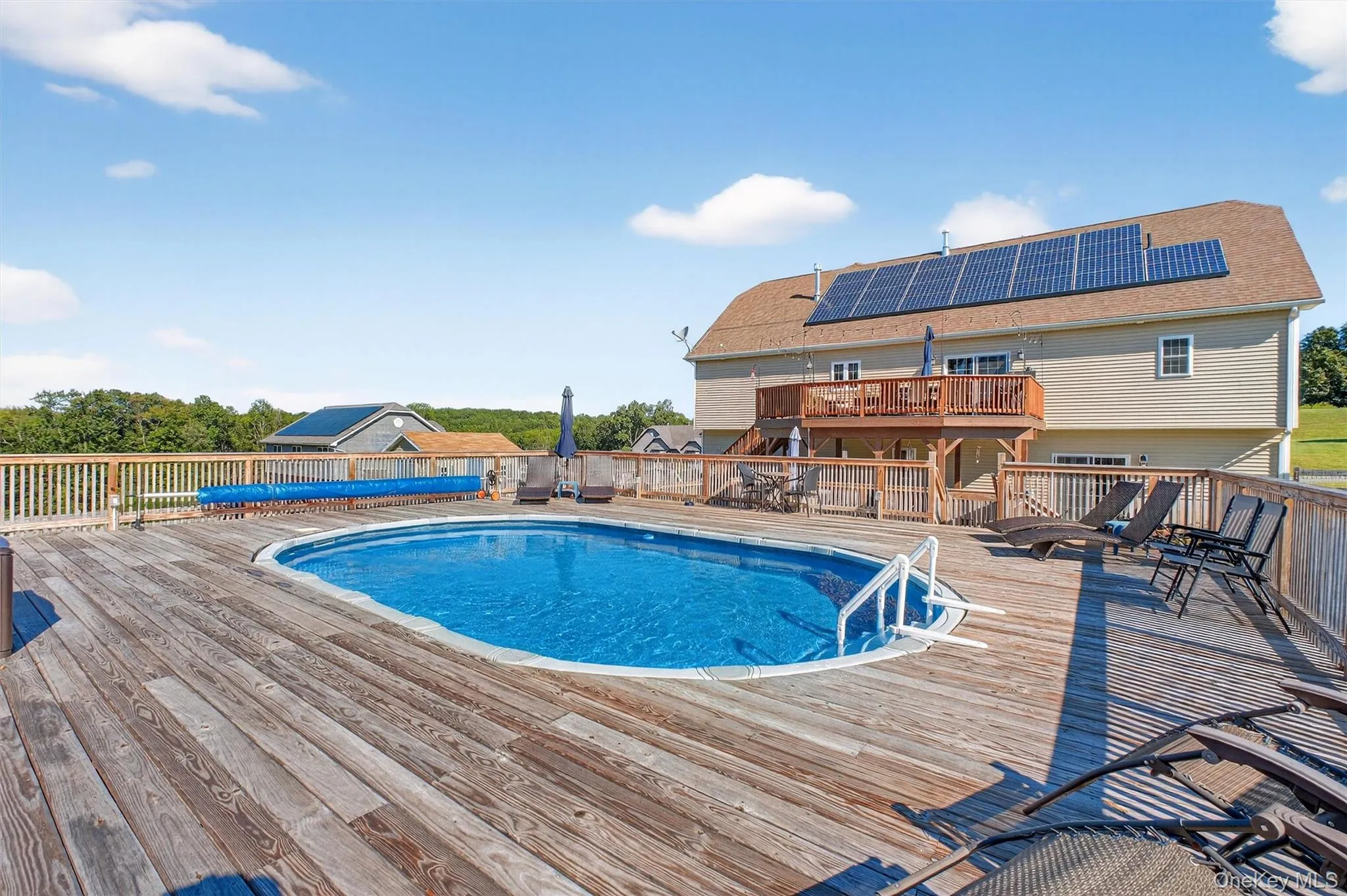 View of pool with a wooden deck View of pool with a wooden deck