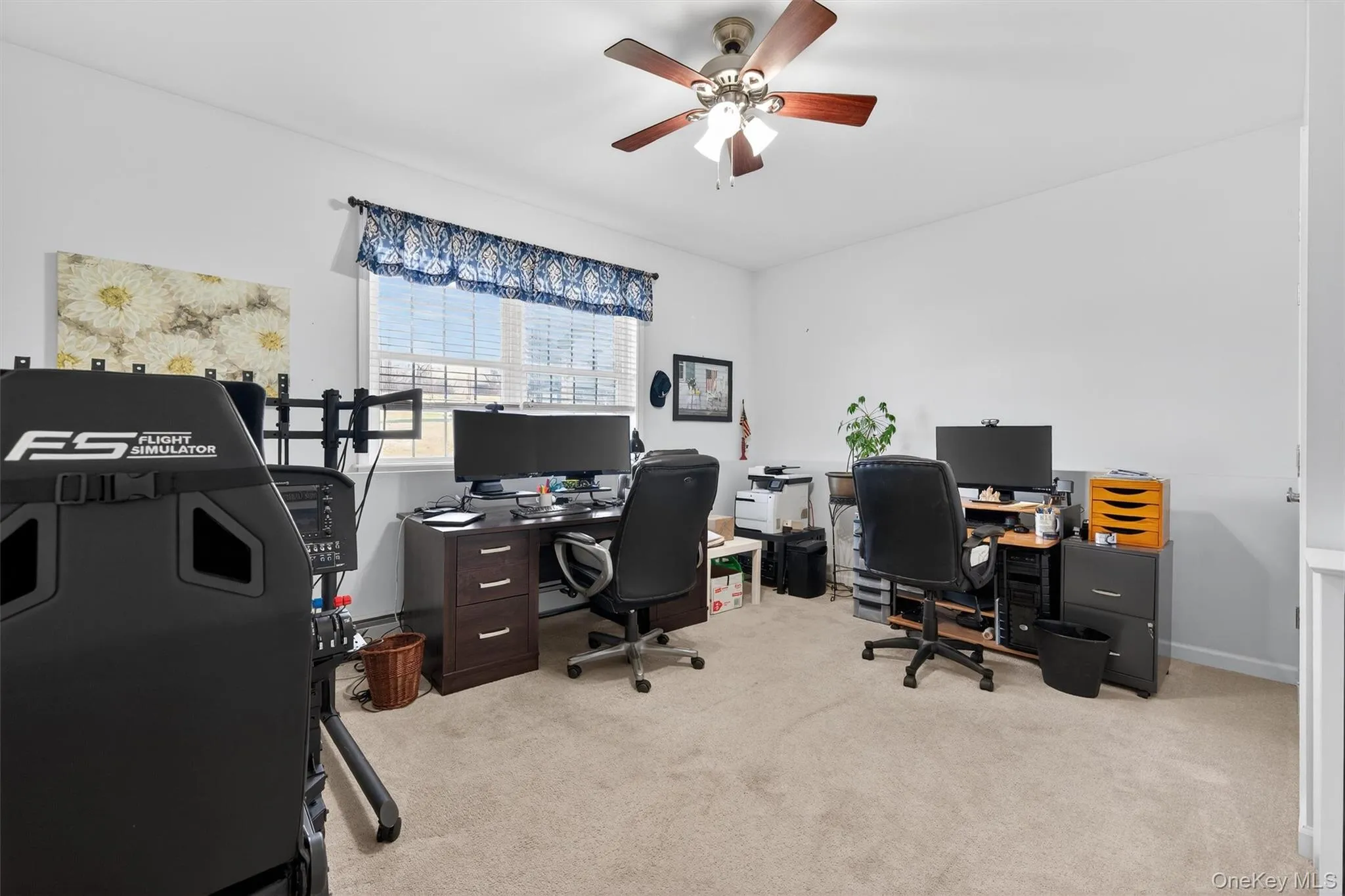 Office space with light colored carpet and ceiling fan Office space with light colored carpet and ceiling fan