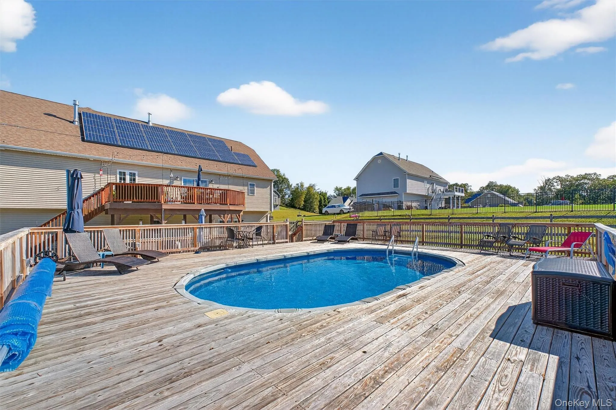 View of swimming pool with a wooden deck View of swimming pool with a wooden deck
