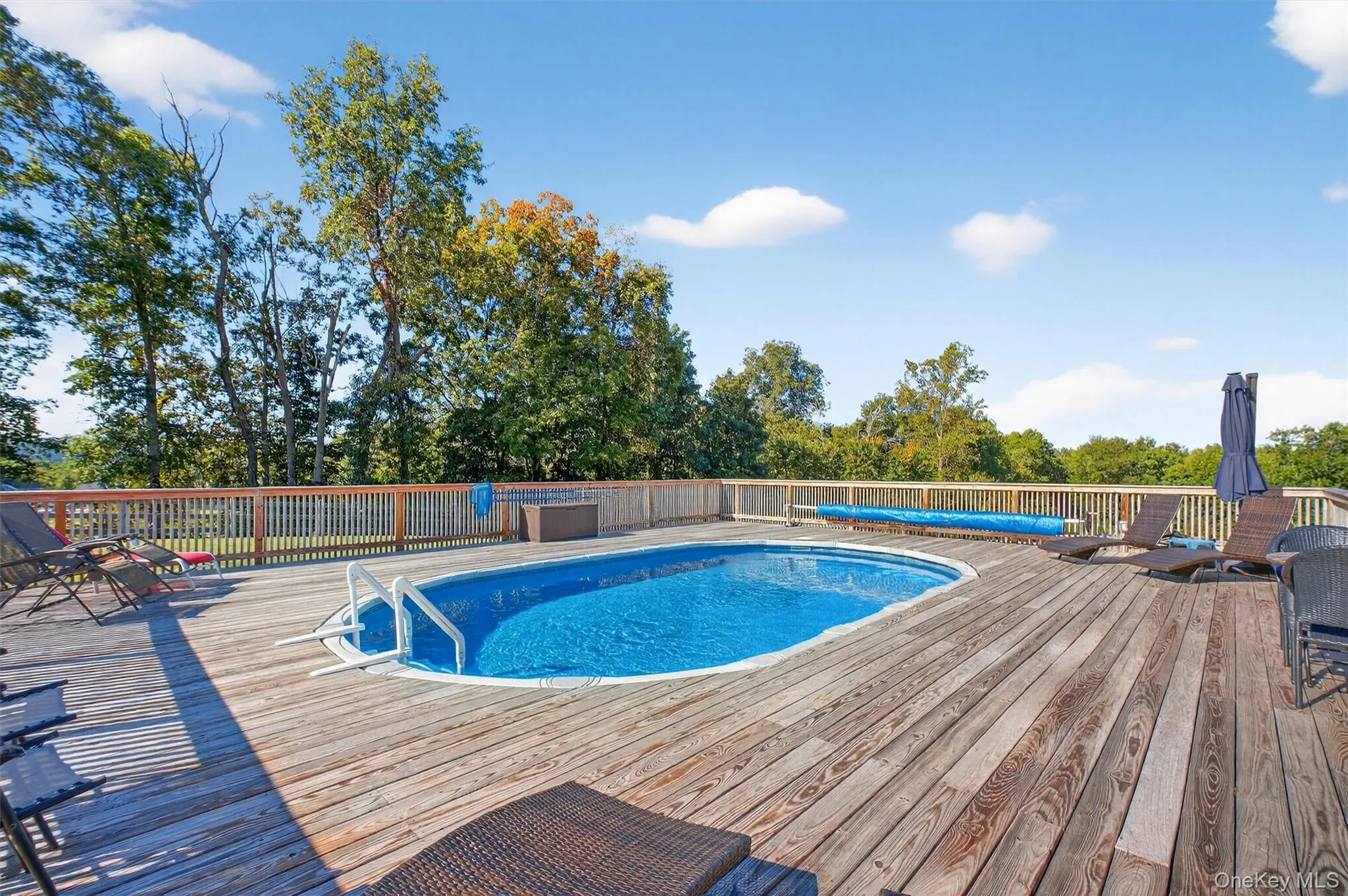 View of swimming pool with a wooden deck View of swimming pool with a wooden deck