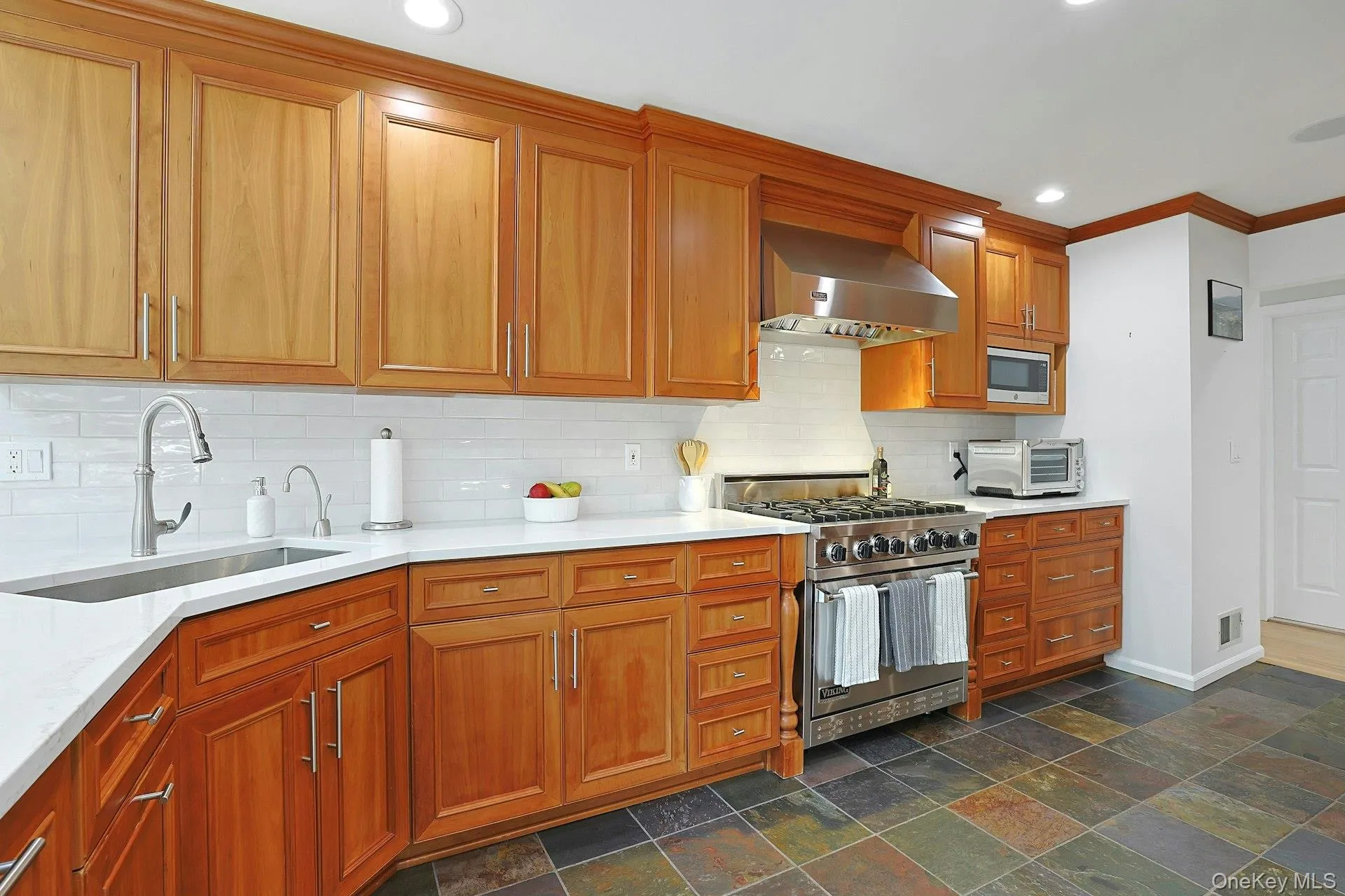 Cherry wood cabinets, soft close draws, quartz counter top, six burner Viking stove, slate floor. Cherry wood cabinets, soft close draws, quartz counter top, six burner Viking stove, slate floor.