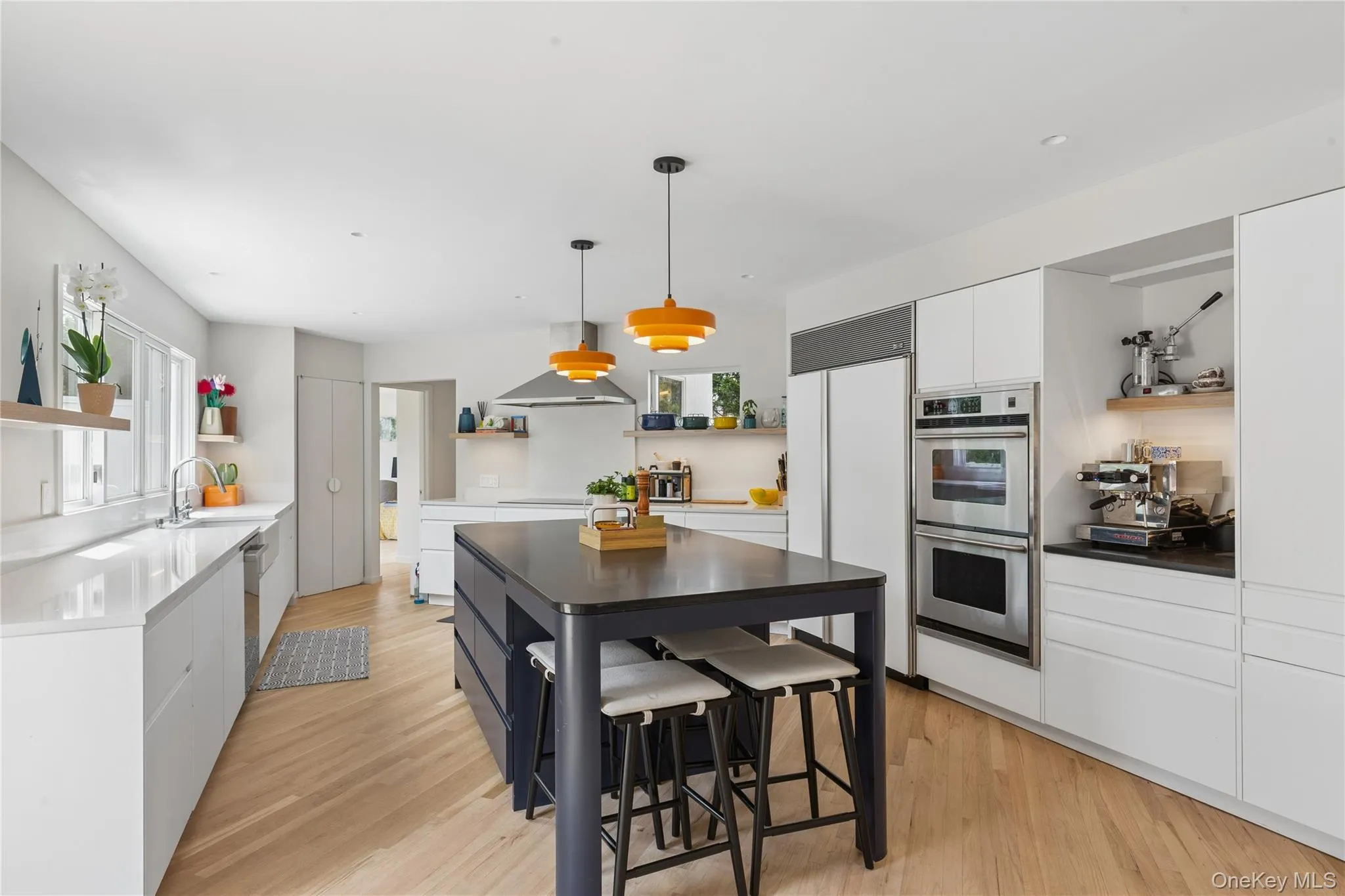 Newly renovated Contemporary kitchen featuring light wood-finish flooring, convection burners, and a central island Newly renovated Contemporary kitchen featuring light wood-finish flooring, convection burners, and a central island