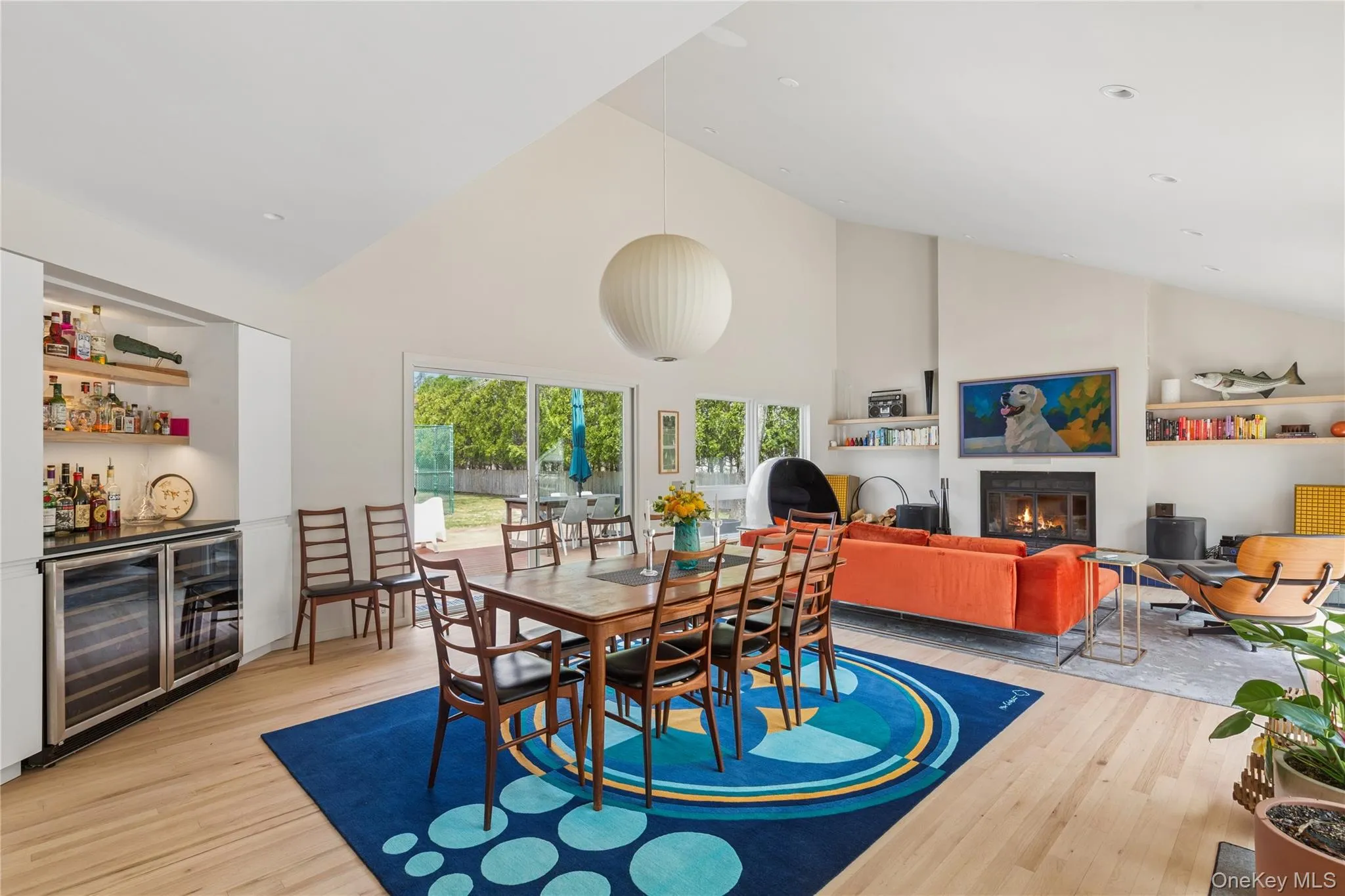 Open-concept living area with wood-finish flooring and a vaulted ceiling Open-concept living area with wood-finish flooring and a vaulted ceiling