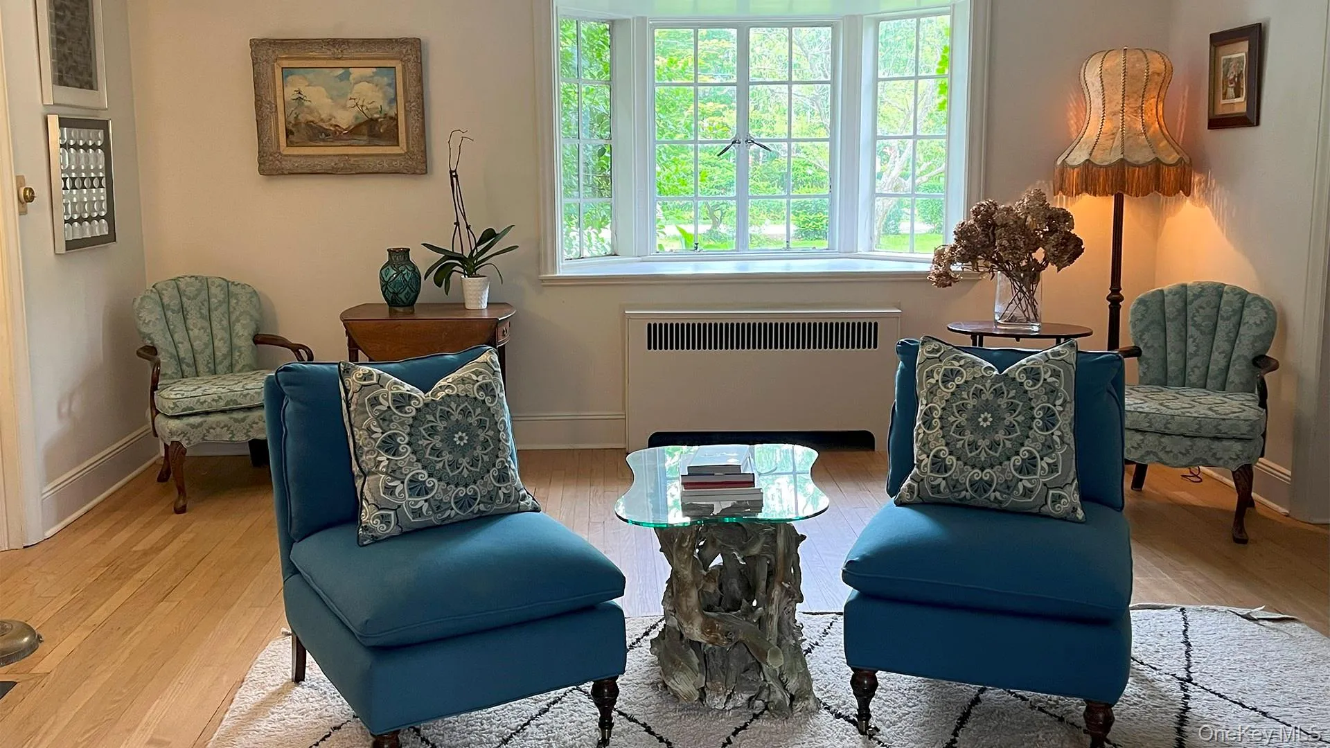 Sitting room with radiator heating unit and wood finished floors Sitting room with radiator heating unit and wood finished floors