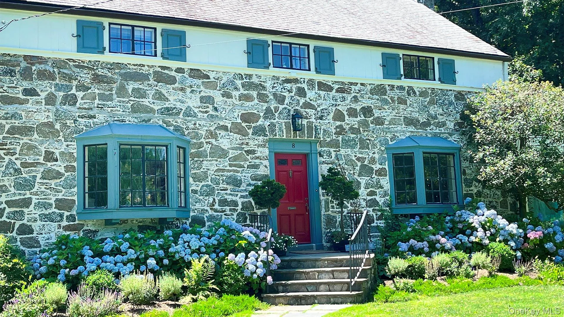 View of front of home featuring stone siding View of front of home featuring stone siding