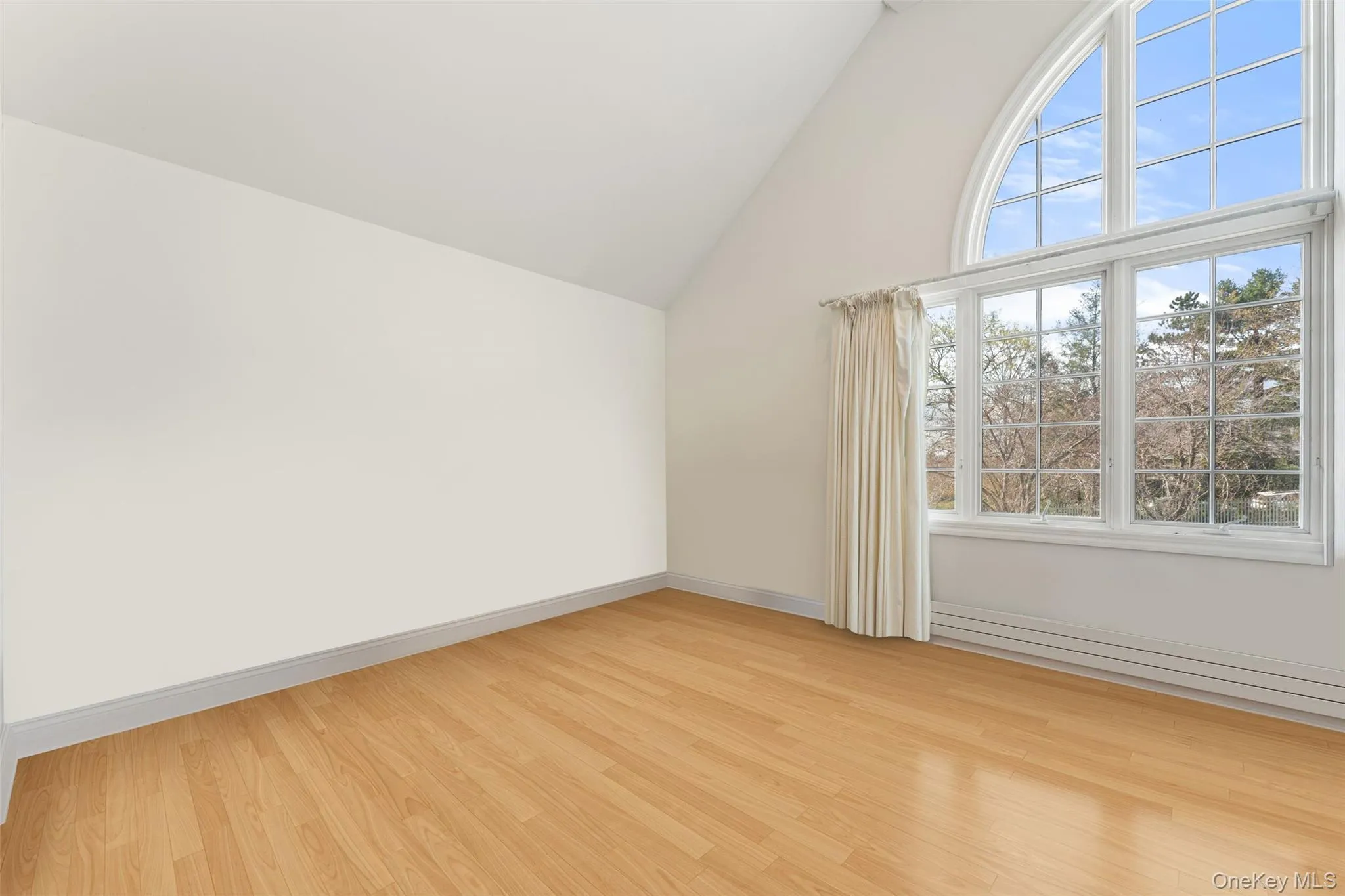 2nd floor bedroom featuring light wood-style flooring and lofted ceiling 2nd floor bedroom featuring light wood-style flooring and lofted ceiling