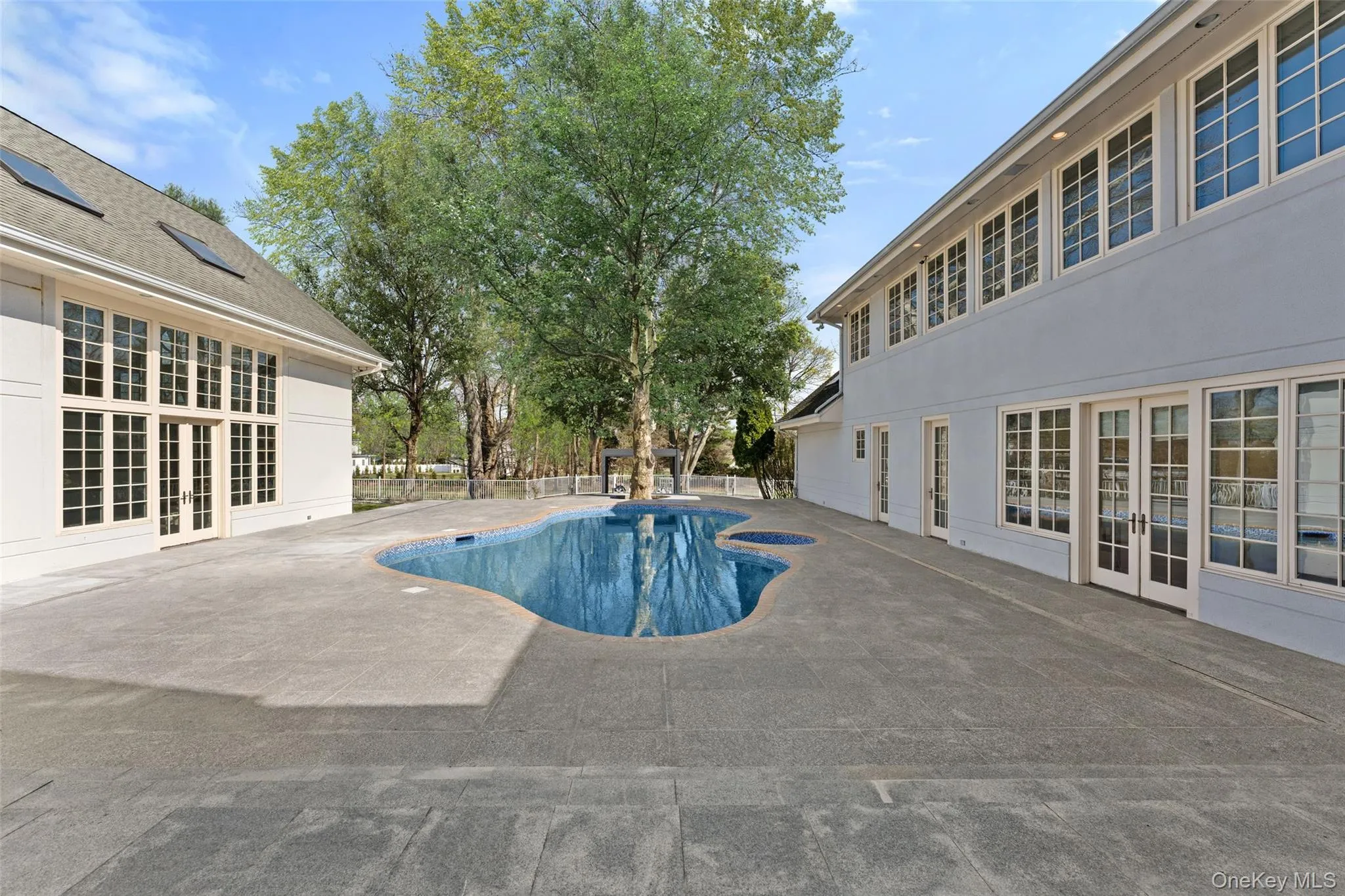 View of pool with french doors and patio surround View of pool with french doors and patio surround