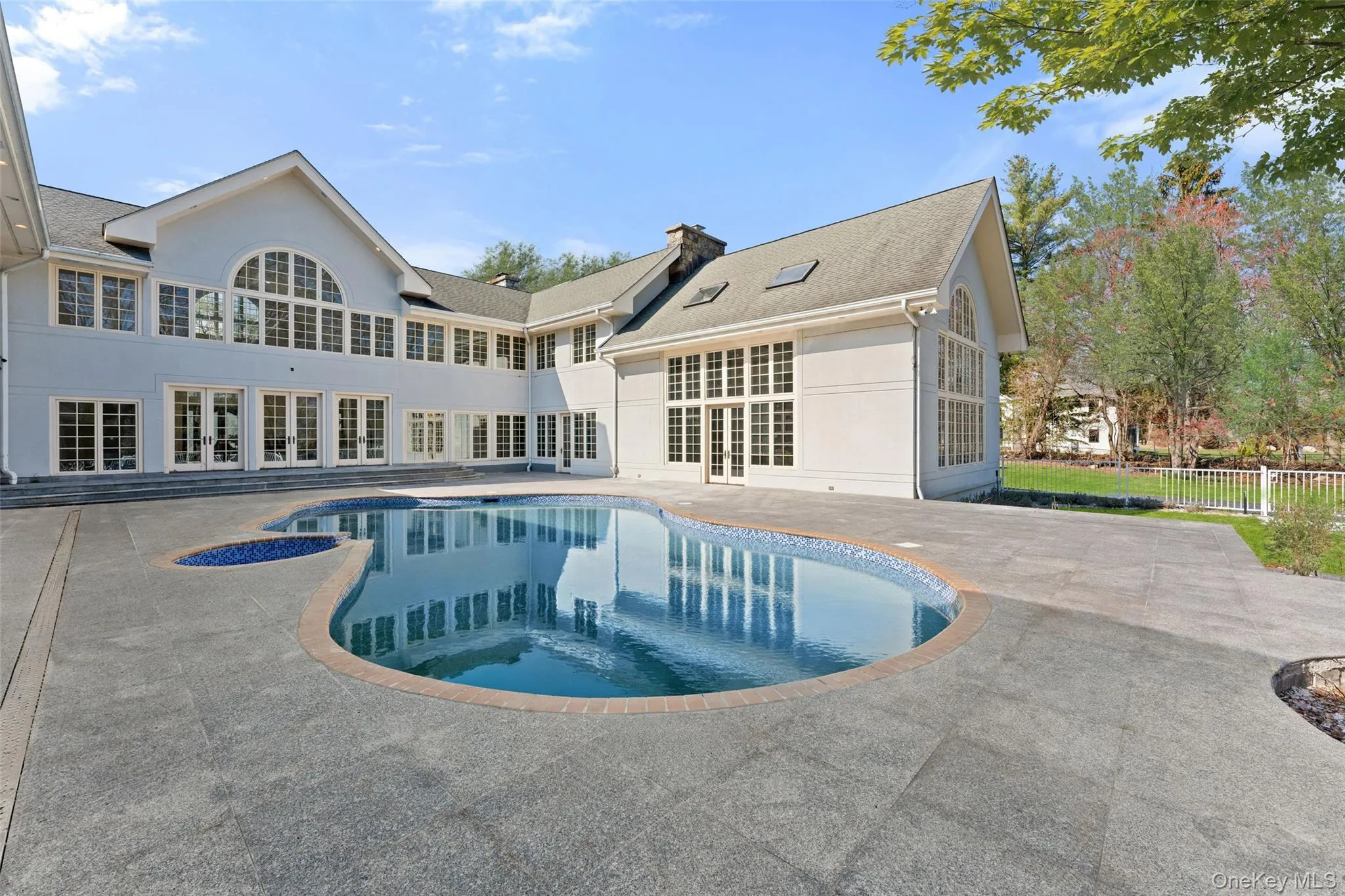View of swimming pool featuring patio surround and french doors View of swimming pool featuring patio surround and french doors