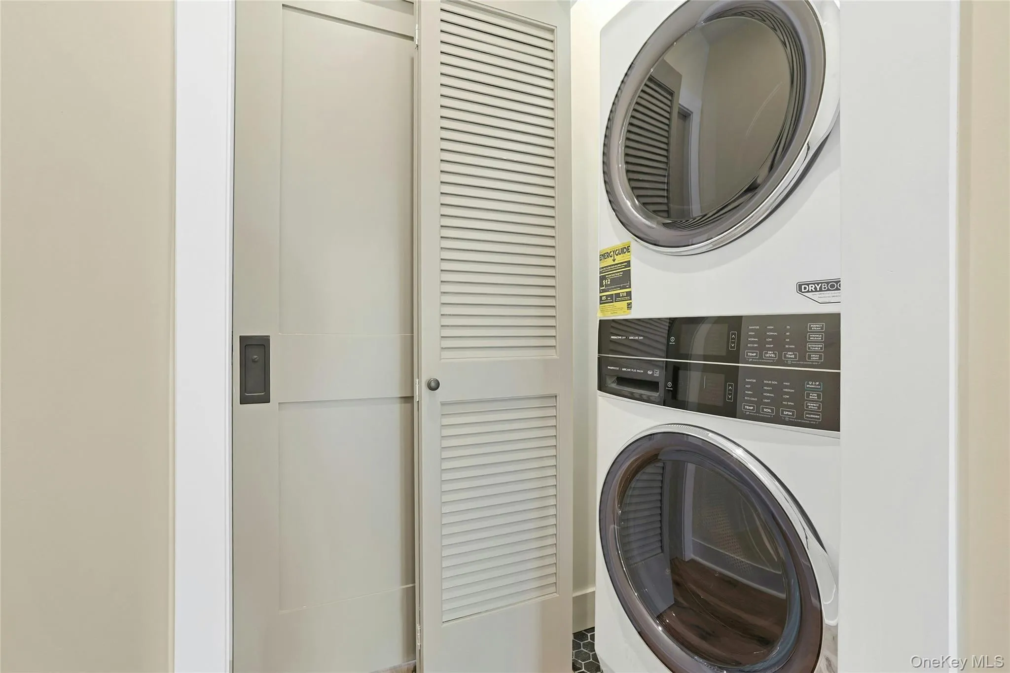 In-unit laundry features new washer and dryer inside closet in hallway. In-unit laundry features new washer and dryer inside closet in hallway.