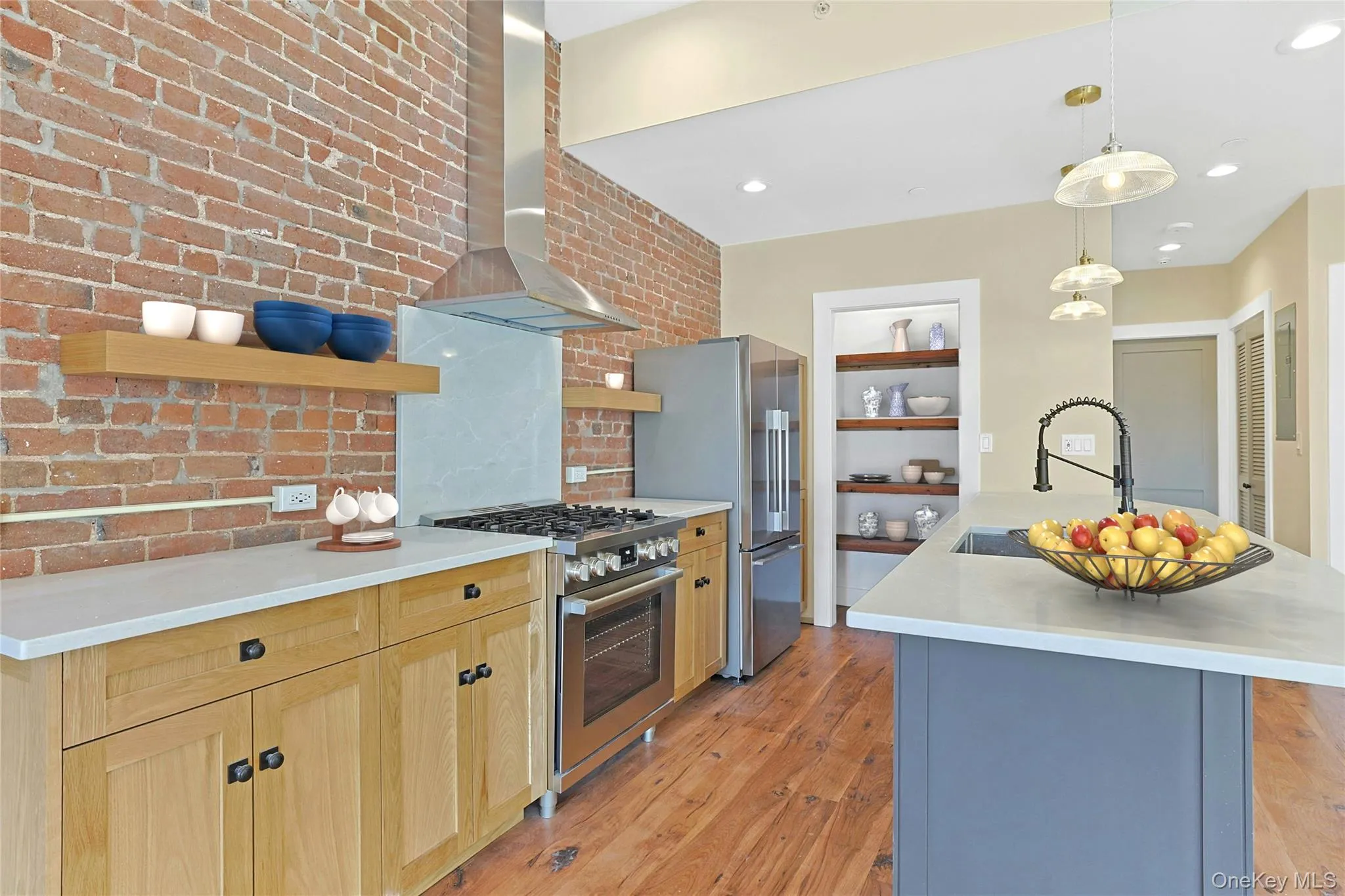 Kitchen featuring all new stainless steel appliances and custom pantry. Kitchen featuring all new stainless steel appliances and custom pantry.