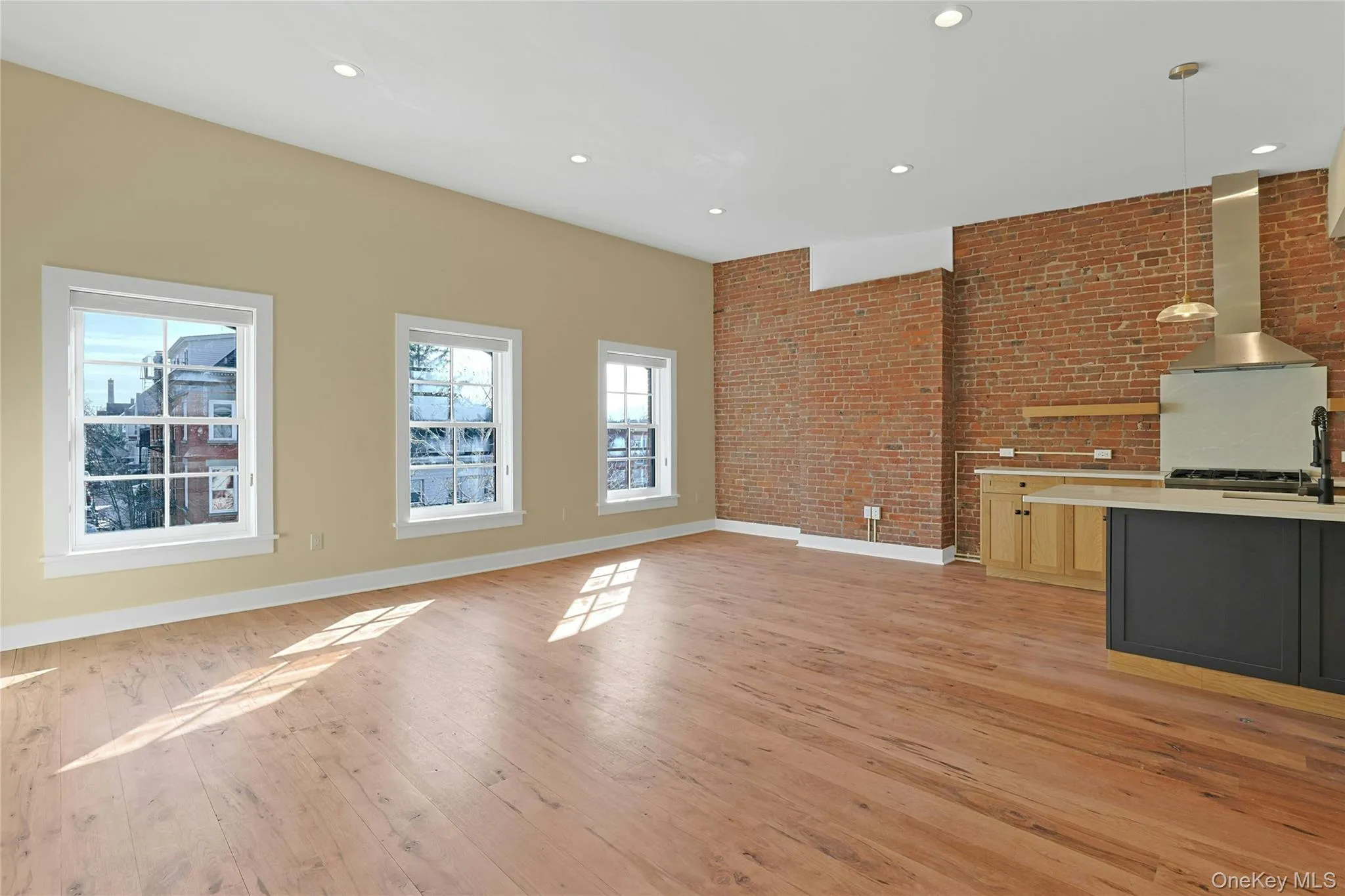 Sun-filled living, dining and kitchen areas. Sun-filled living, dining and kitchen areas.