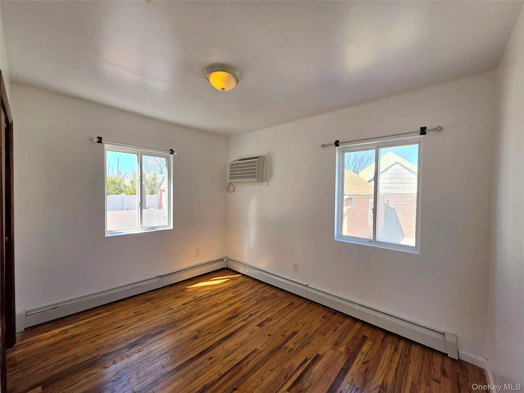 Unfurnished 3rd bedroom featuring dark wood-style flooring and a closet. AC in room Unfurnished 3rd bedroom featuring dark wood-style flooring and a closet. AC in room