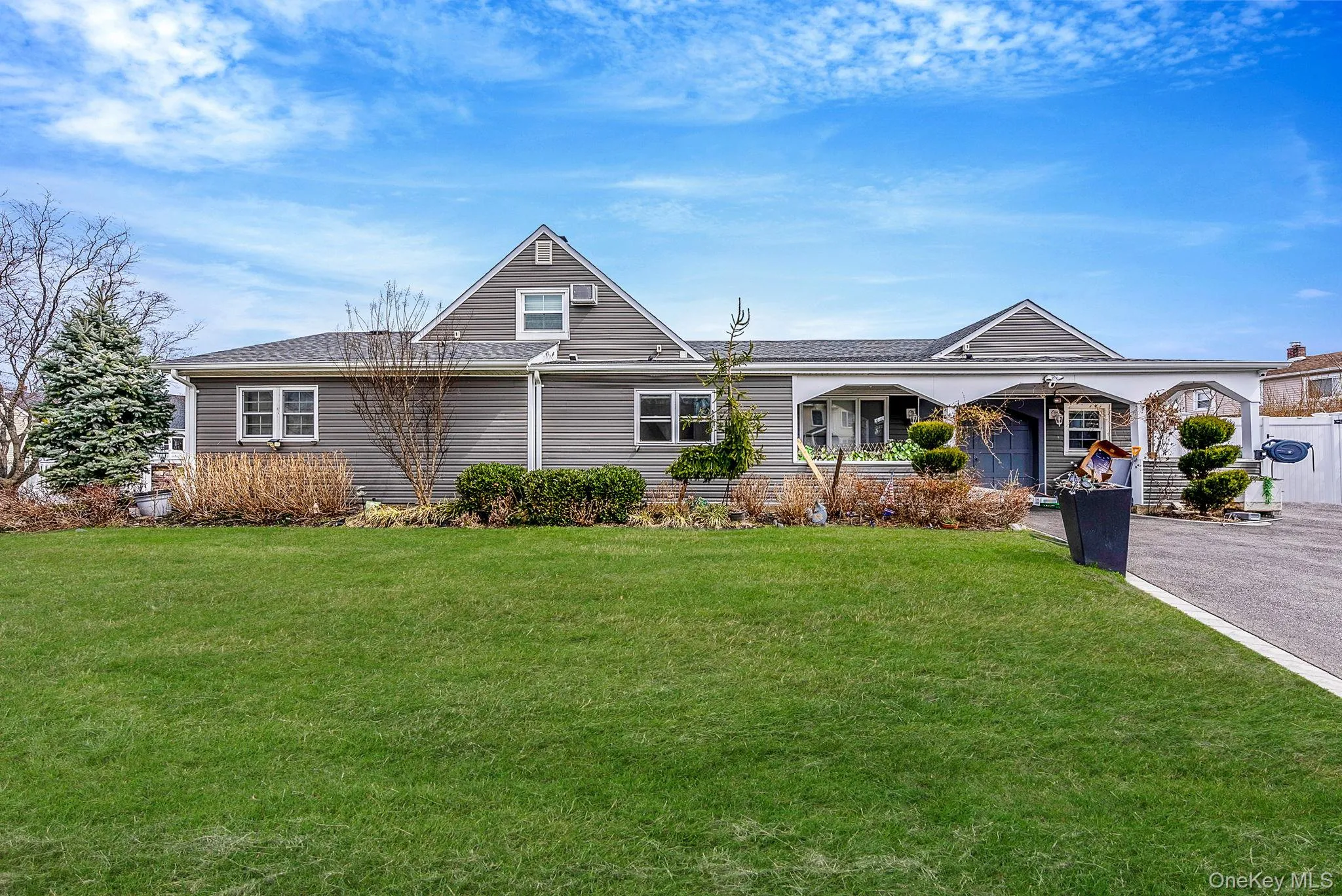 View of front of house with a front yard and a shingled roof View of front of house with a front yard and a shingled roof