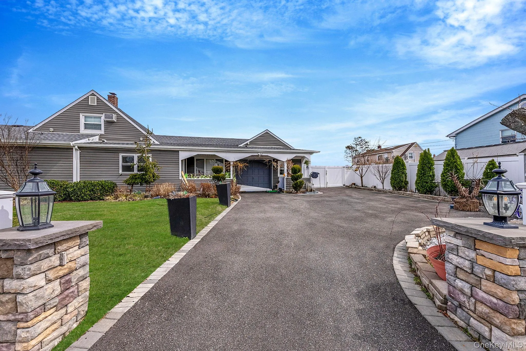 View of front of home featuring asphalt driveway, a garage, roof with shingles, and a gate View of front of home featuring asphalt driveway, a garage, roof with shingles, and a gate