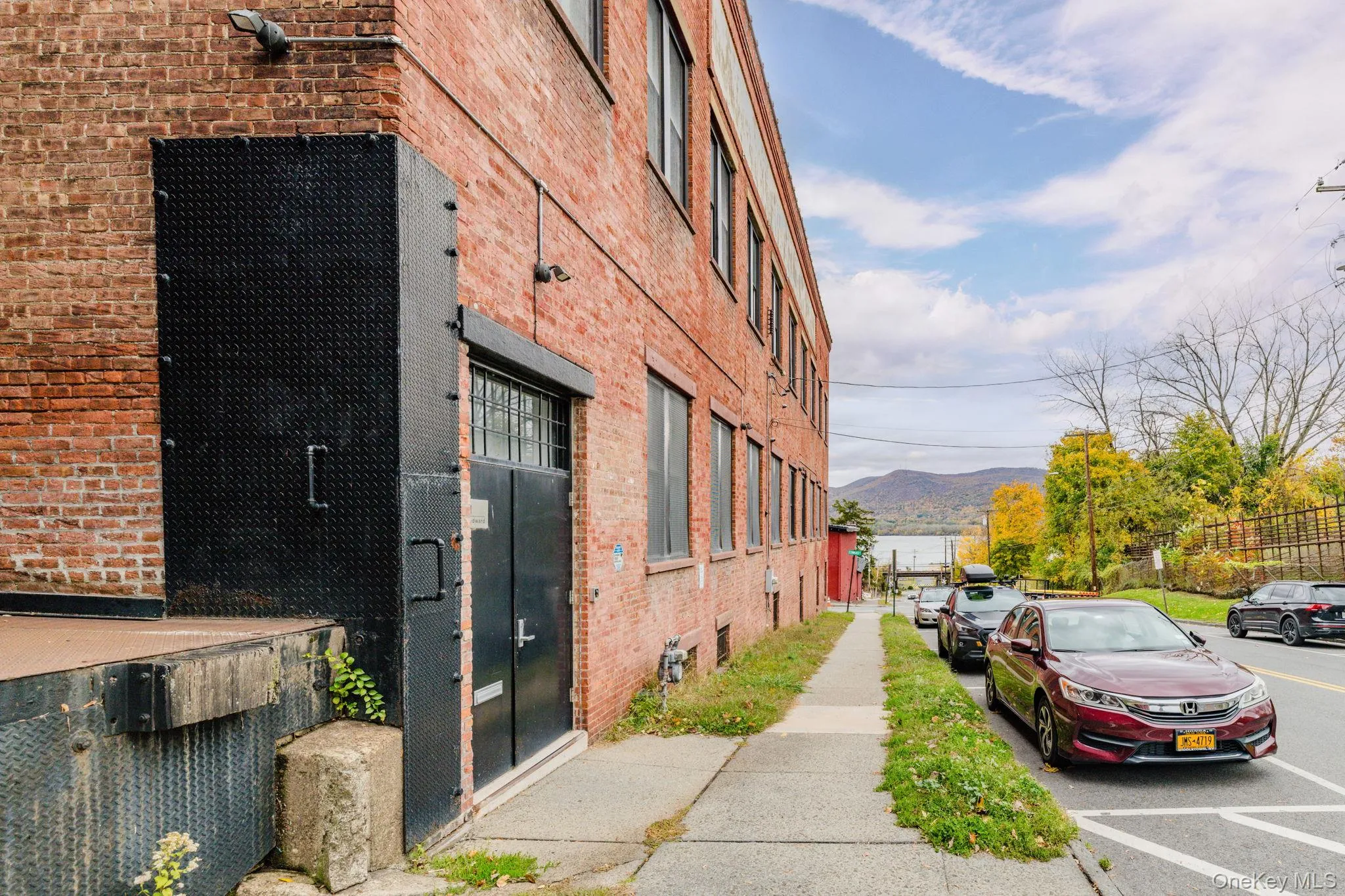 View of building exterior main entrance featuring a mountain and Hudson River view View of building exterior main entrance featuring a mountain and Hudson River view