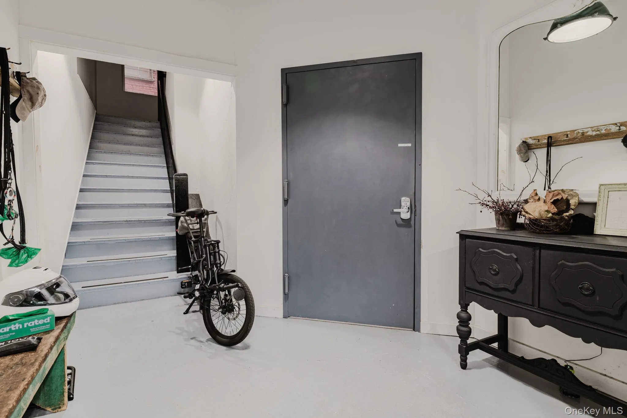 Entryway featuring stairs and finished concrete floors Entryway featuring stairs and finished concrete floors