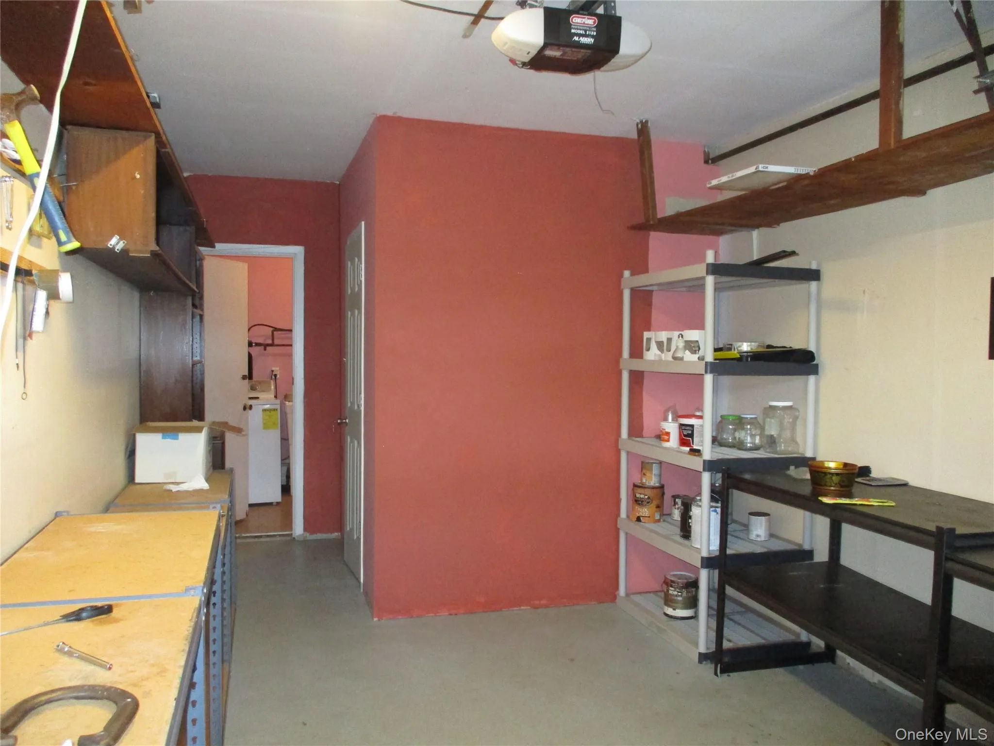 Storage area featuring a garage and washer / clothes dryer Storage area featuring a garage and washer / clothes dryer