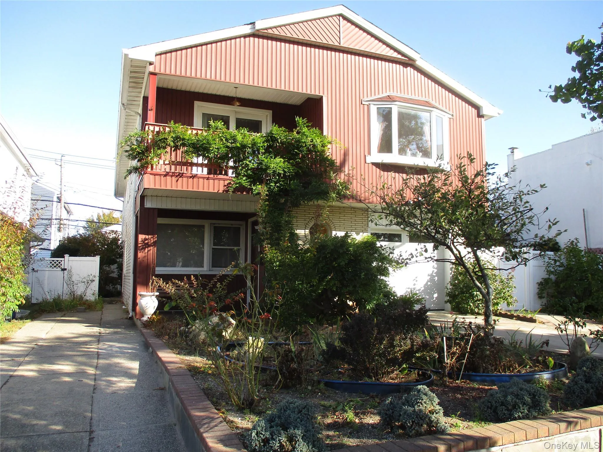 View of front of property with a balcony View of front of property with a balcony
