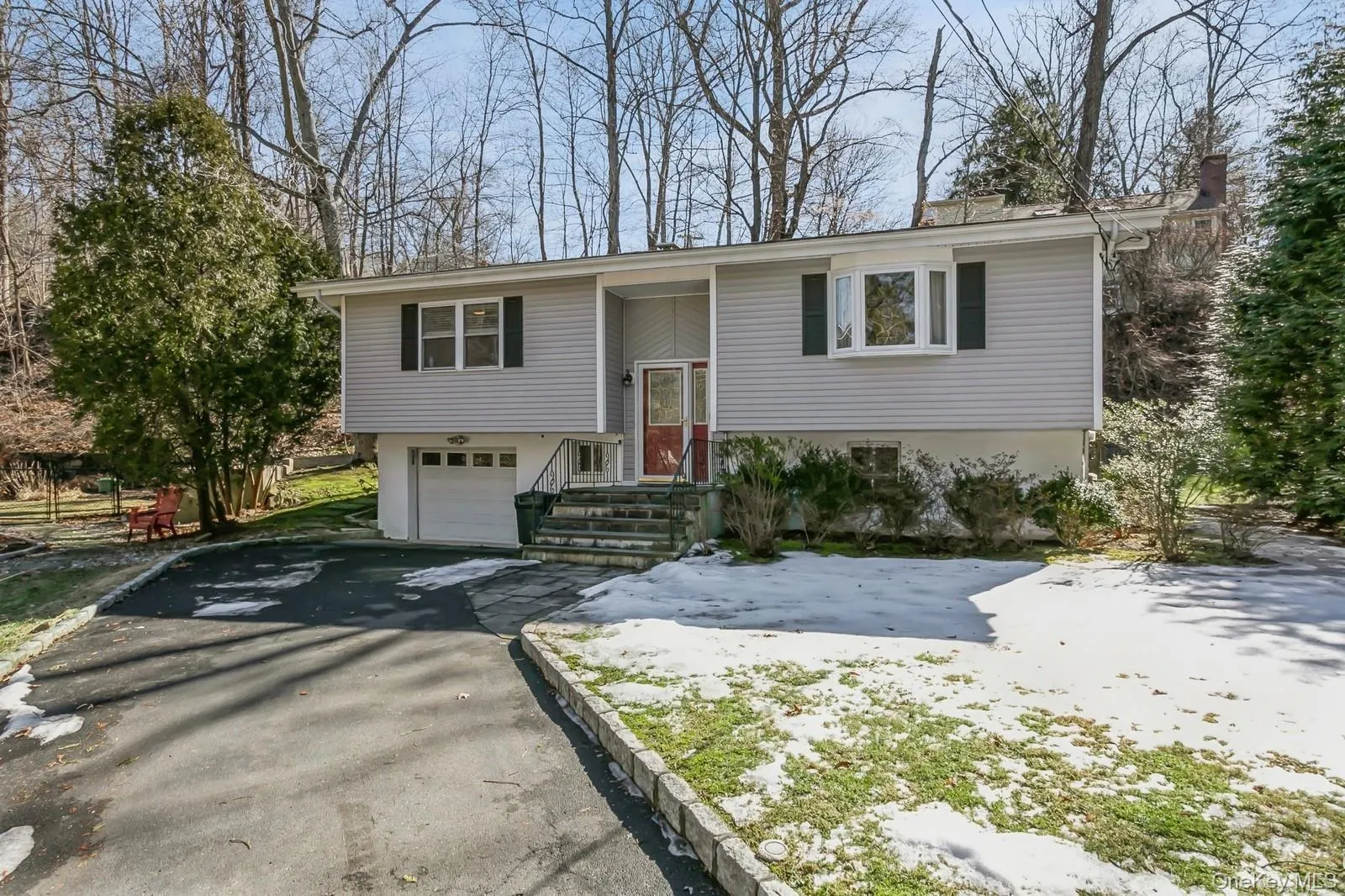 Bi-level home with a garage and driveway Bi-level home with a garage and driveway