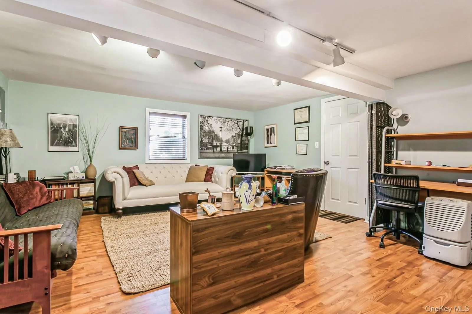 Family room with light wood-style flooring and track lighting Family room with light wood-style flooring and track lighting