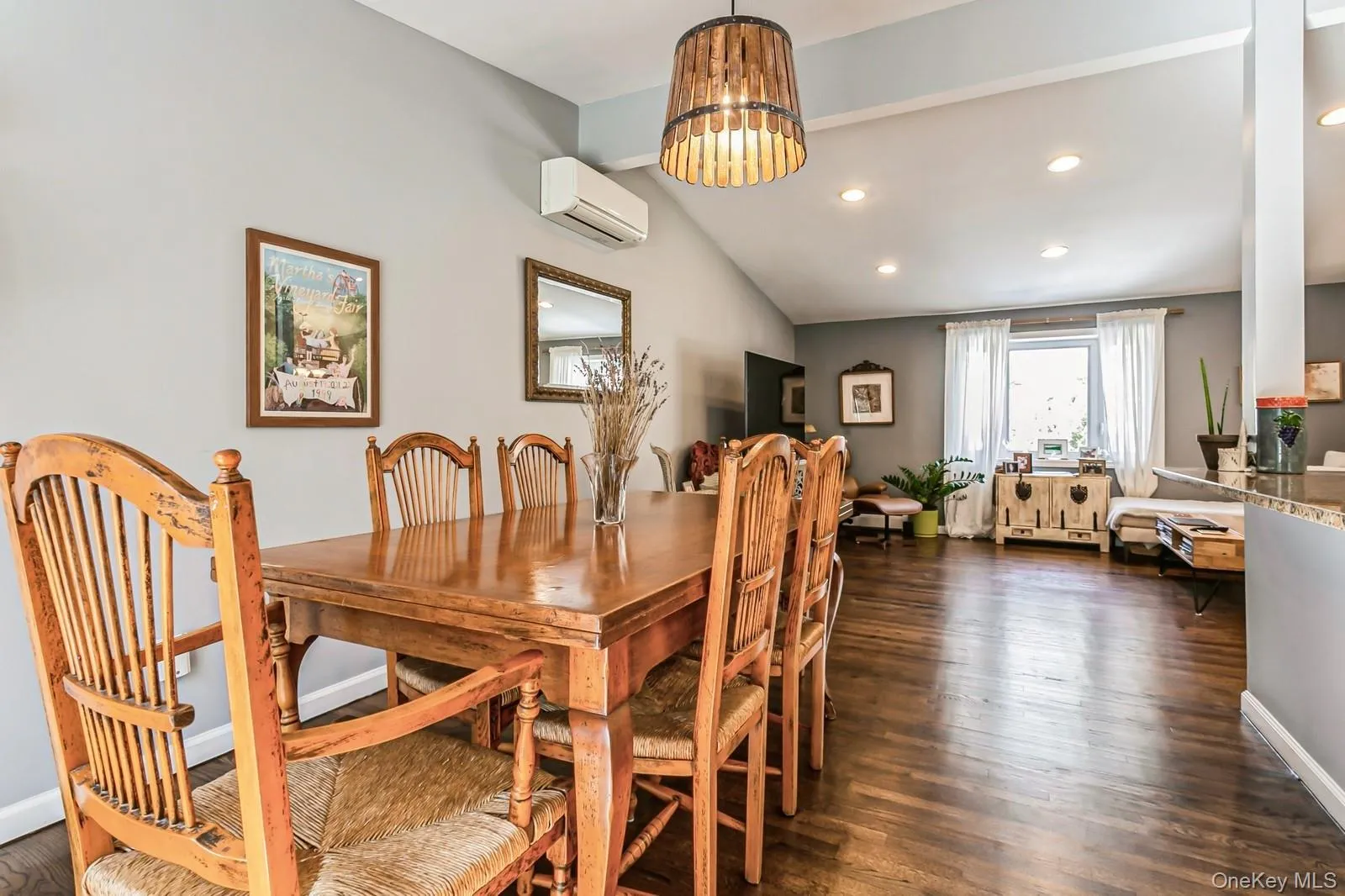 Dining room with recessed lighting, dark wood-style flooring, baseboards, vaulted ceiling, and a wall mounted air conditioner Dining room with recessed lighting, dark wood-style flooring, baseboards, vaulted ceiling, and a wall mounted air conditioner